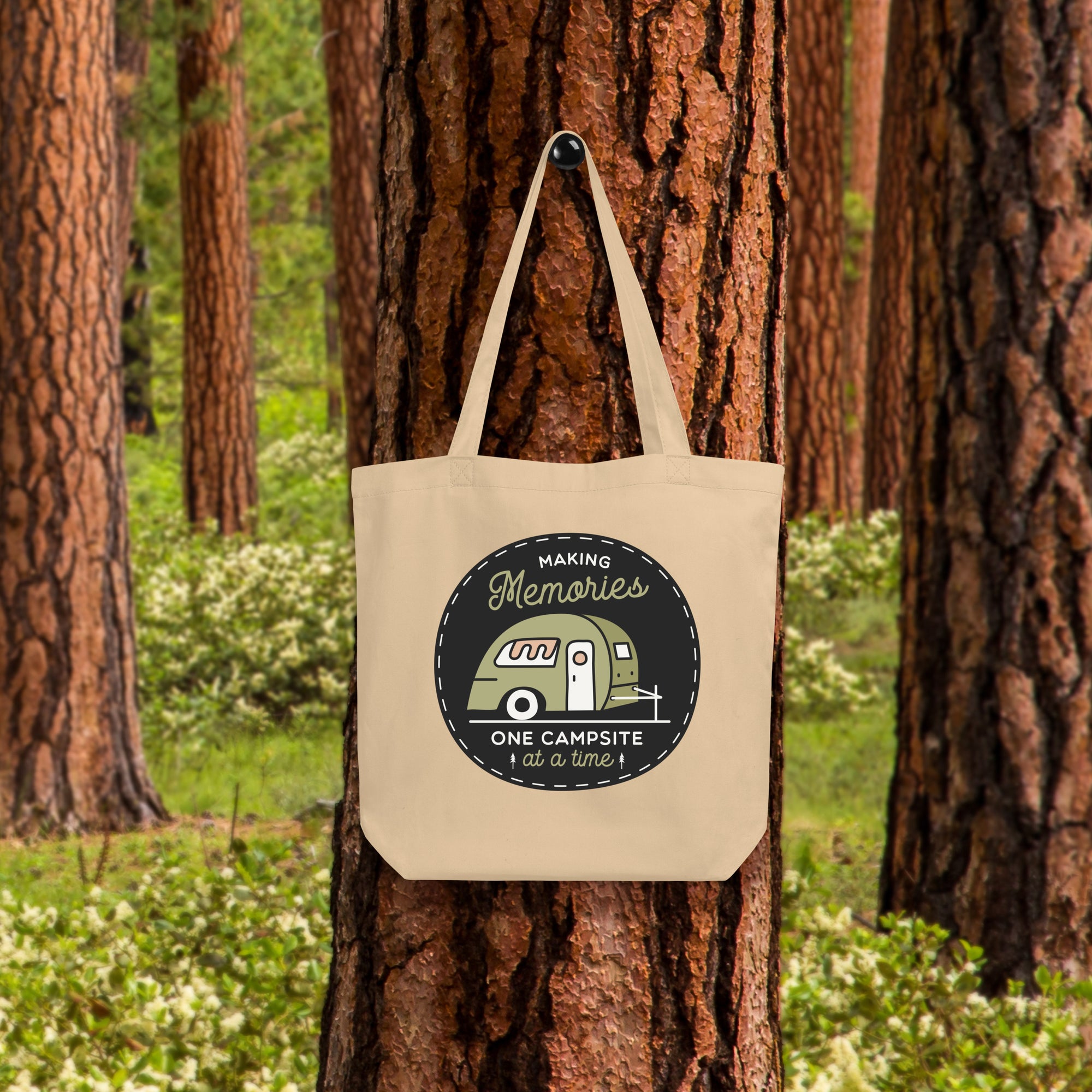 a tote bag hanging on a tree in a forest