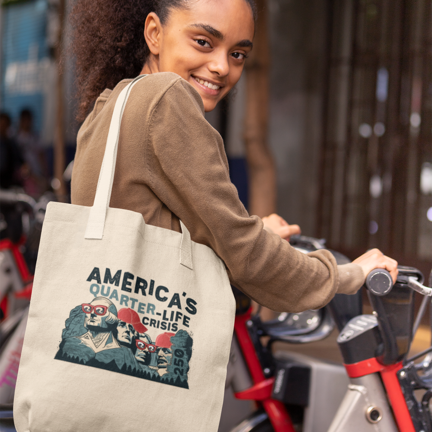 a woman is smiling while holding a tote bag