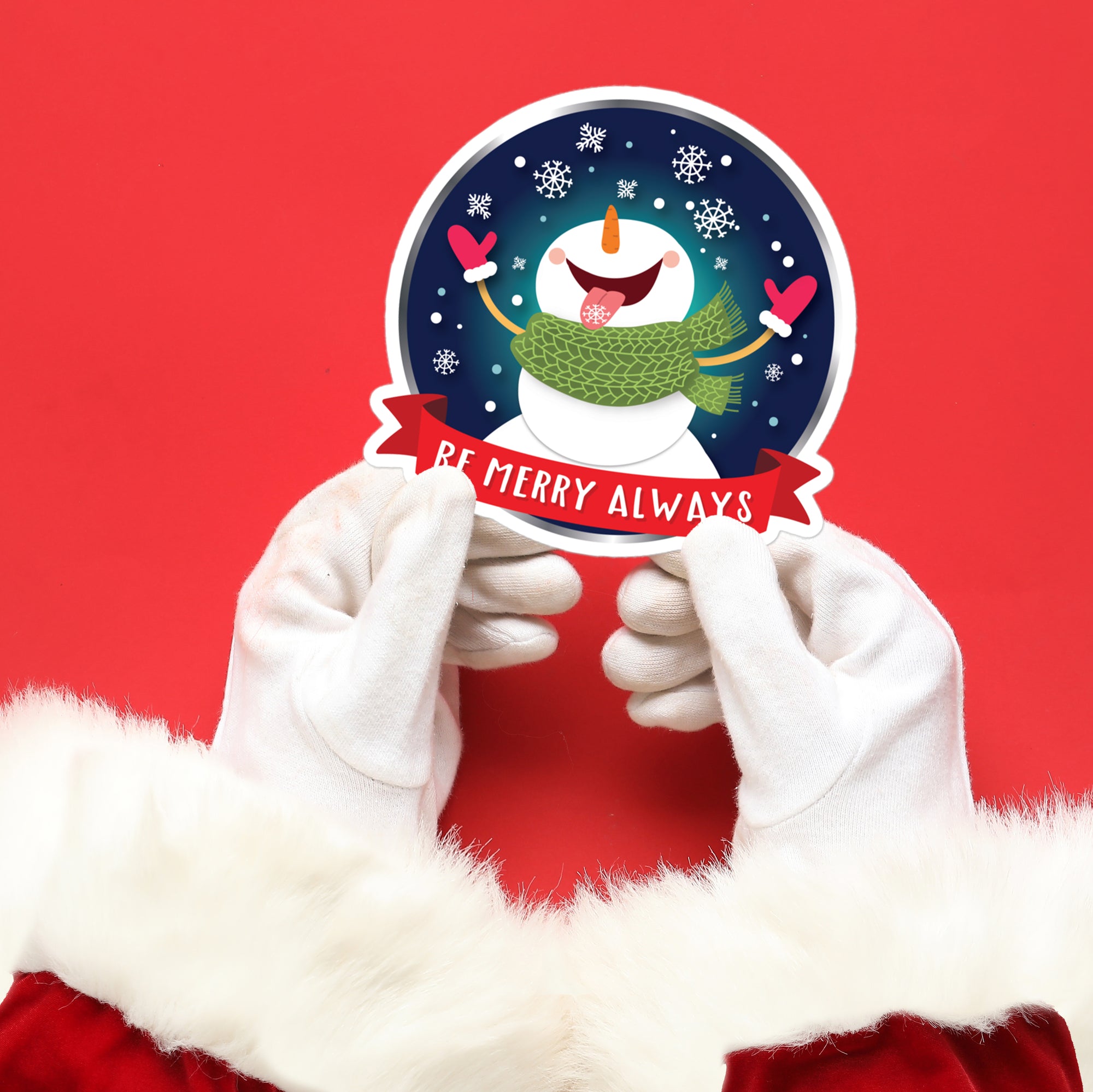 a person in a santa suit holding up a snowman sticker