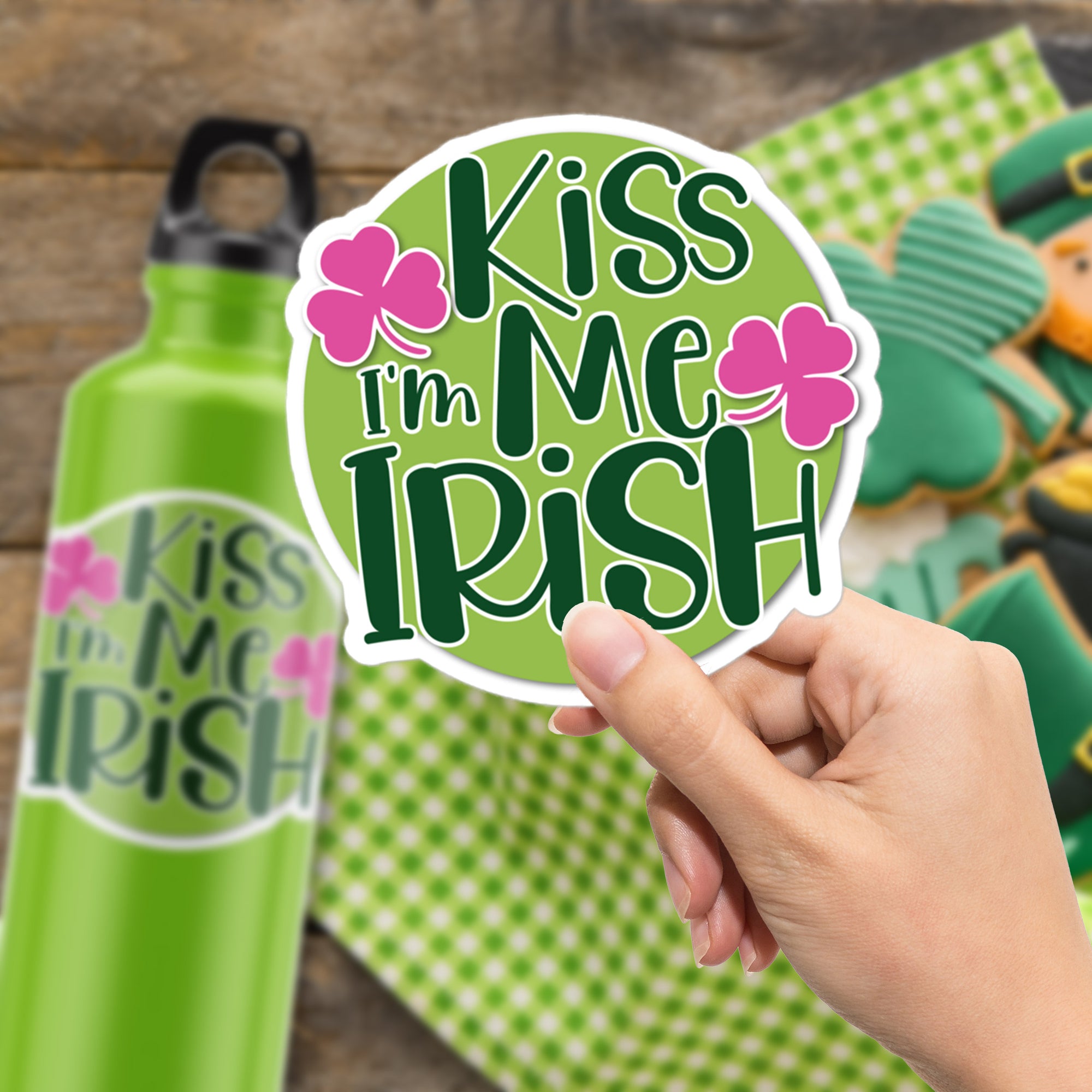 a hand holding a sticker that says kiss me irish