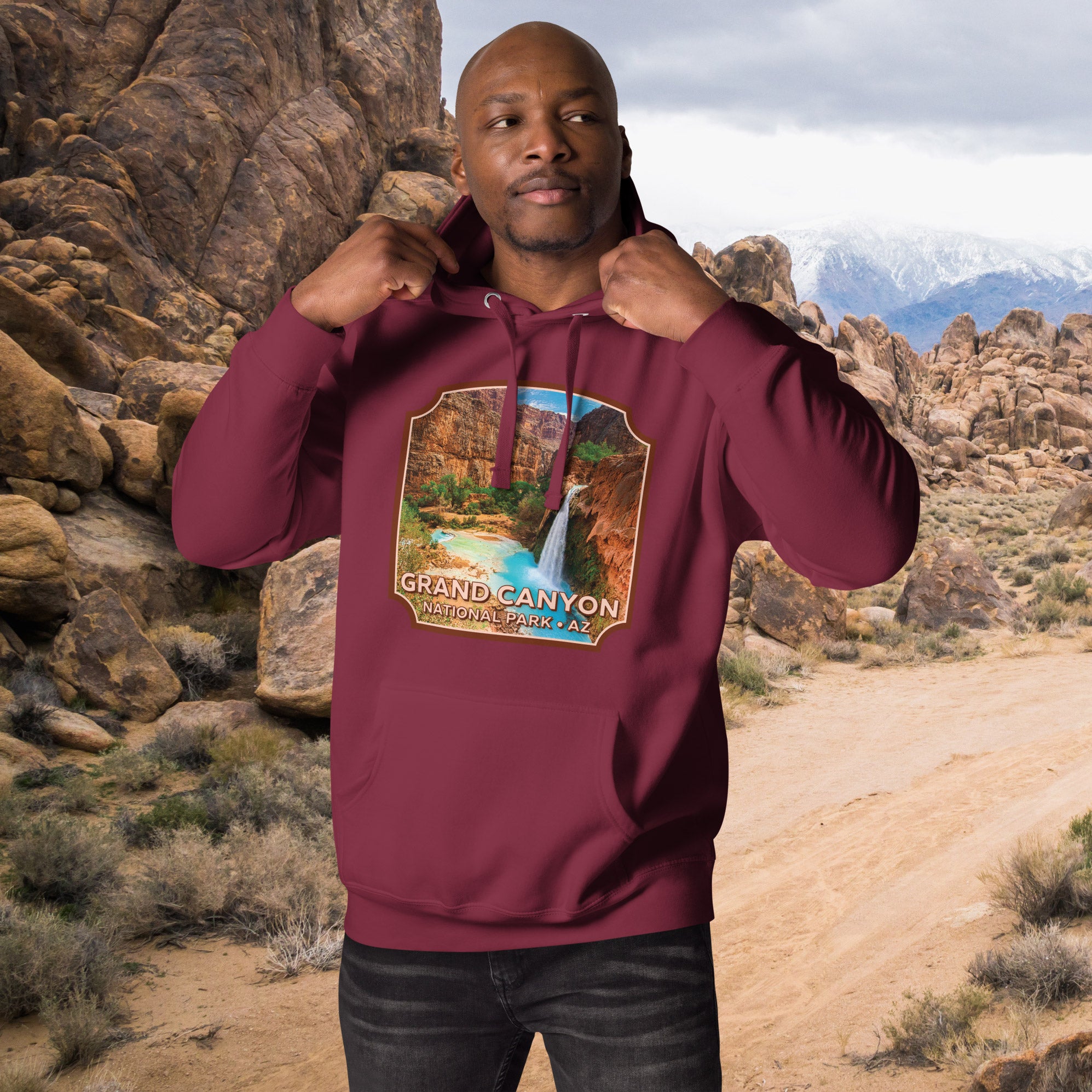 a man in a maroon hoodie is posing for a picture