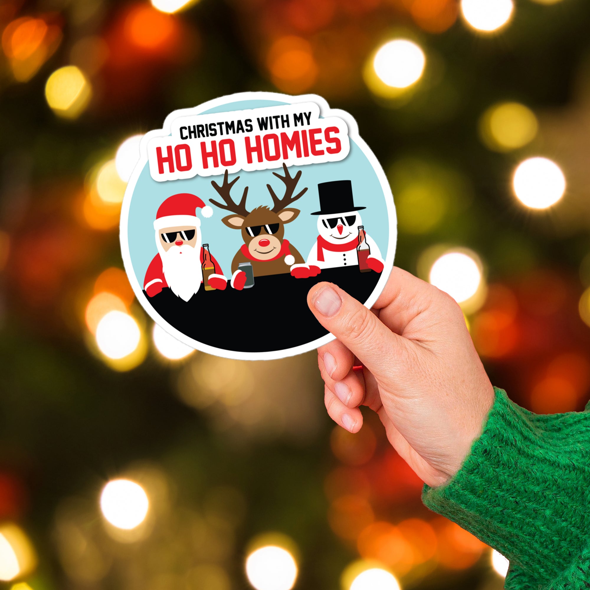 a person holding up a sticker with a picture of a reindeer