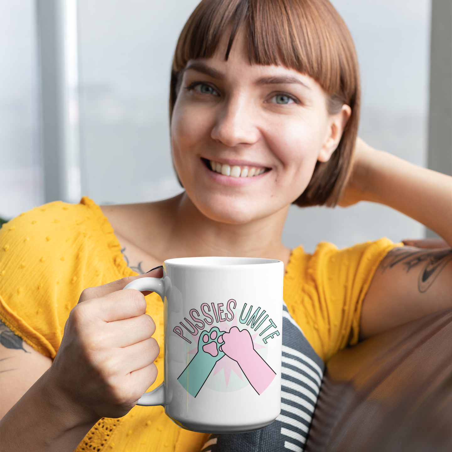 a woman sitting on a couch holding a coffee mug