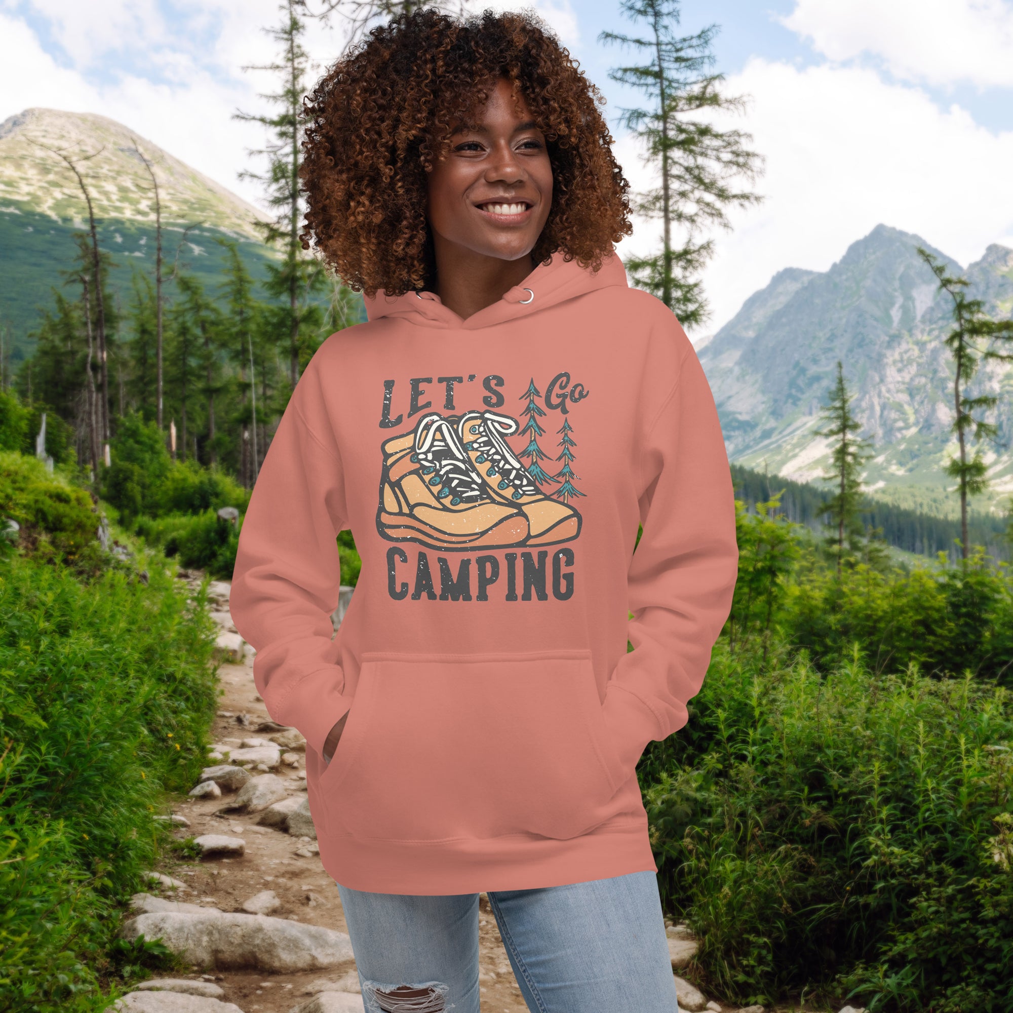 a woman wearing a pink hoodie that says let's go camping