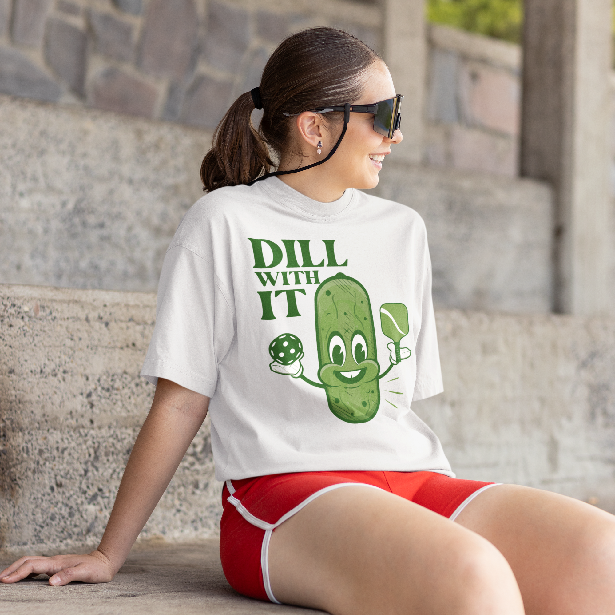 a woman wearing a t - shirt with a pickle on it