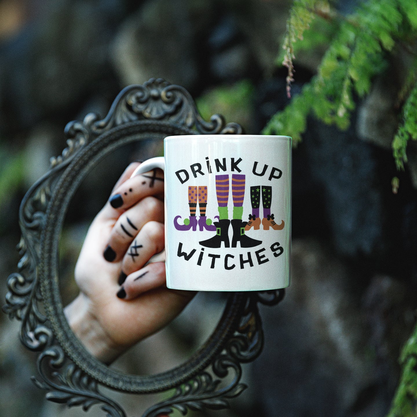 a woman holding a coffee mug with the words drink up witches on it