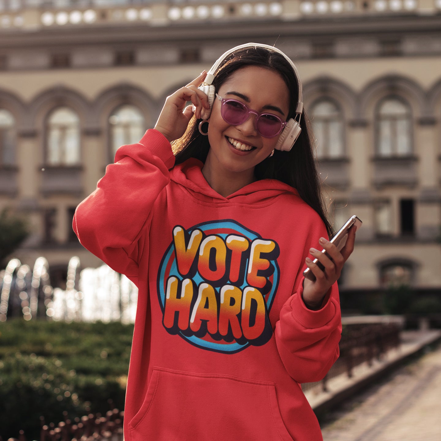 a woman wearing a red sweatshirt and headphones