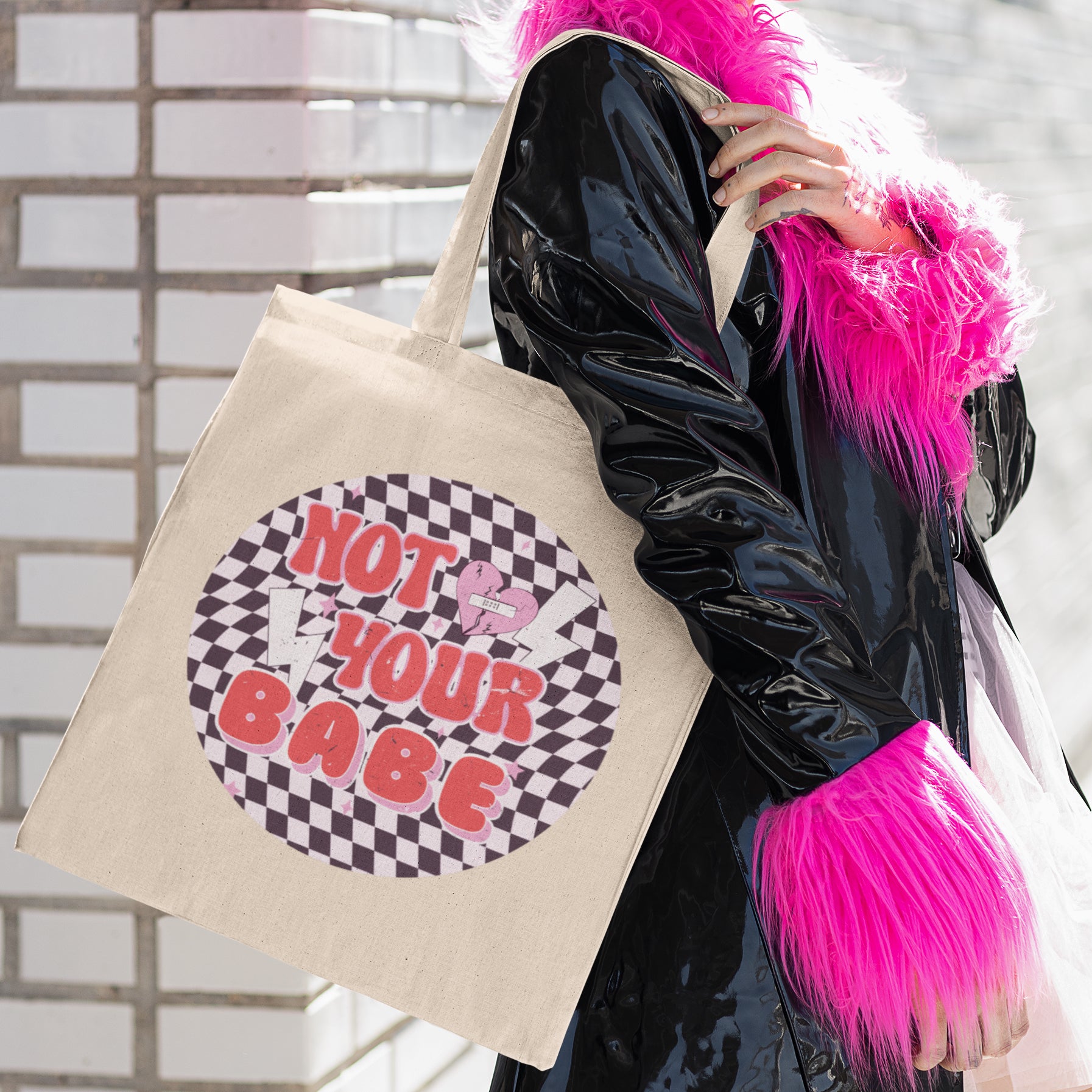 a woman carrying a tote bag with a design on it