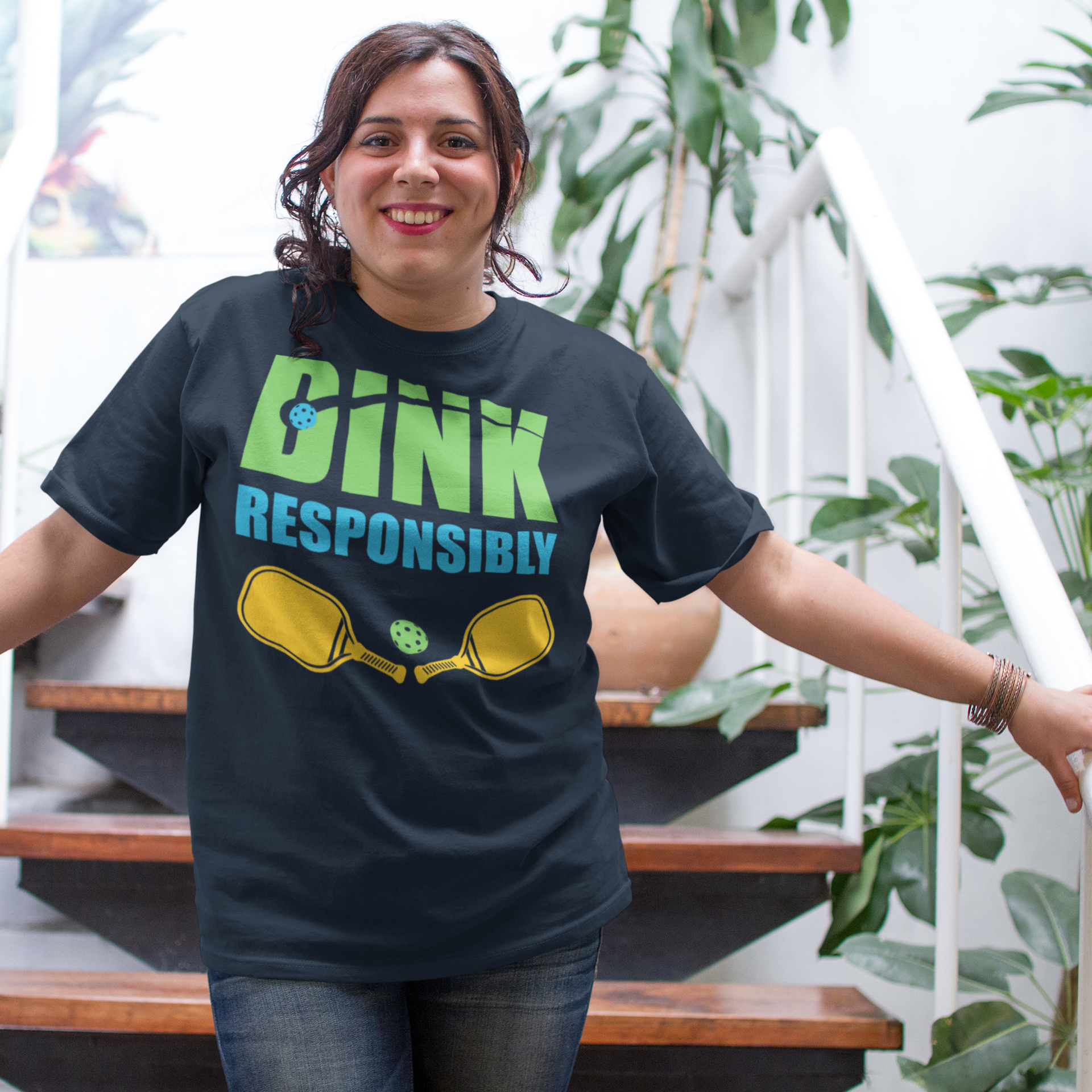 a woman in a black shirt is standing on some stairs