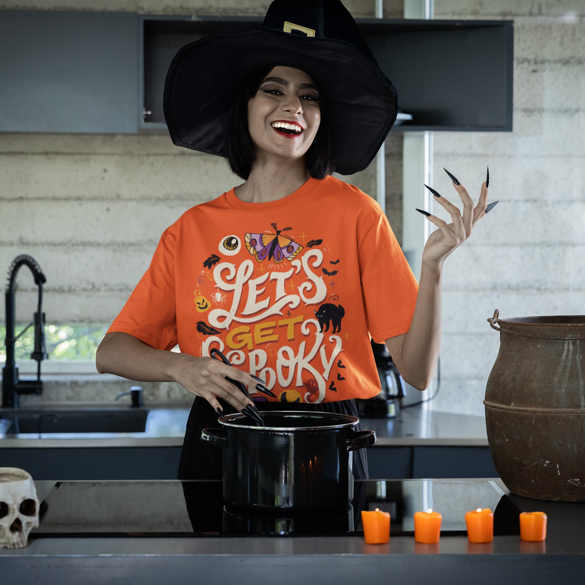 a woman wearing a witches hat and holding a pot