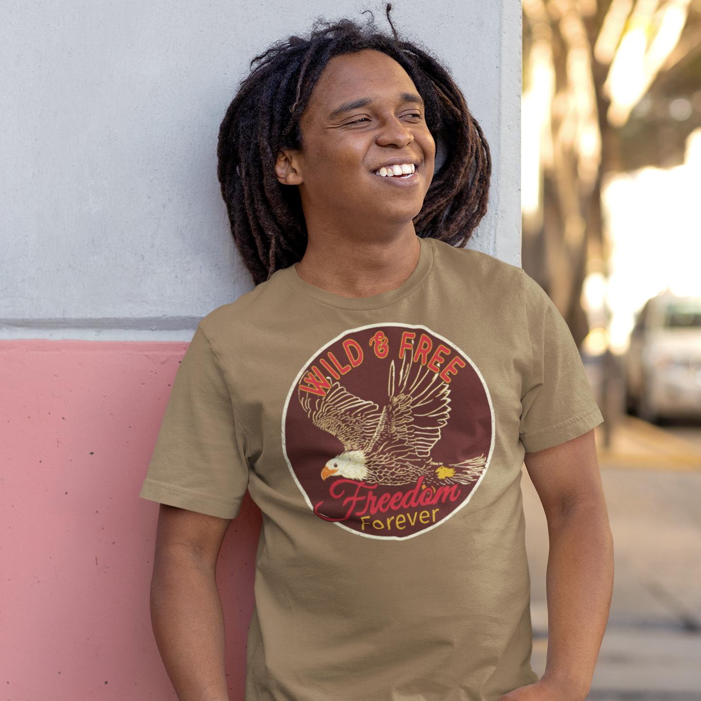 a man with dreadlocks standing next to a wall