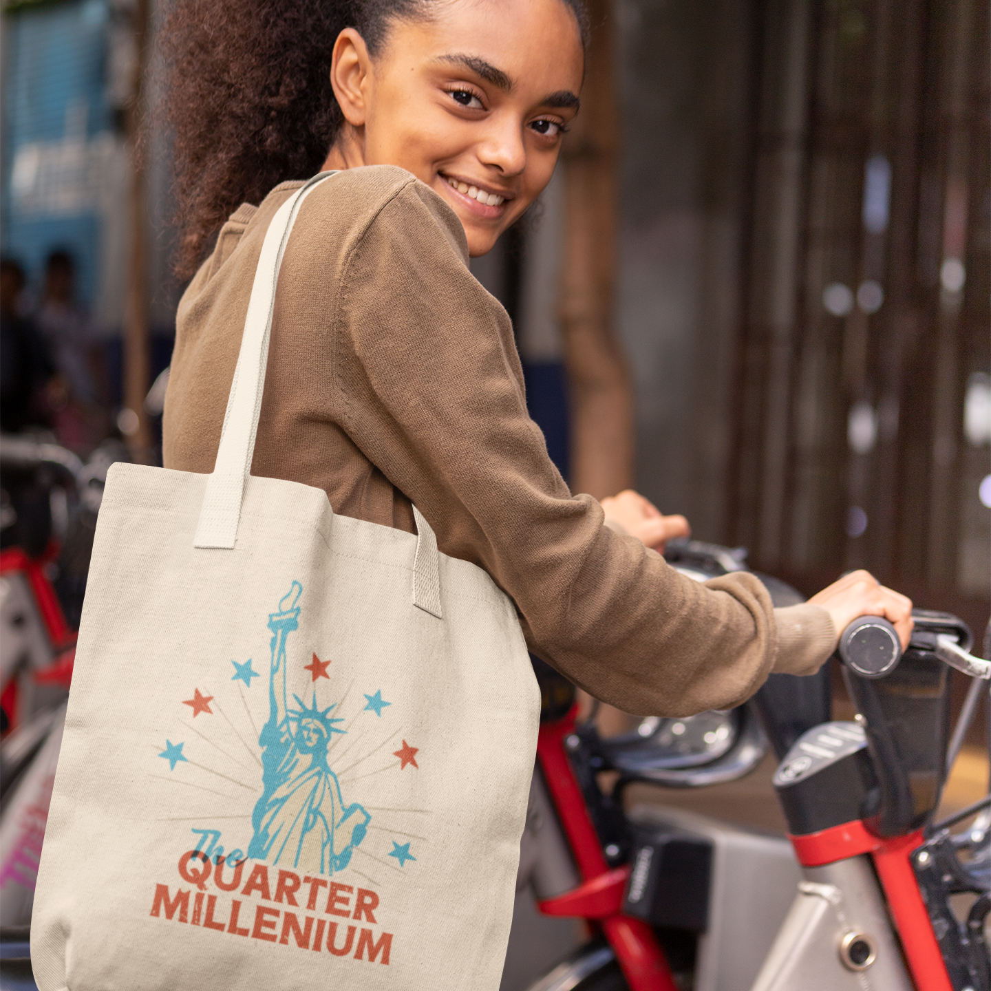 a smiling woman with a tote bag on her shoulder