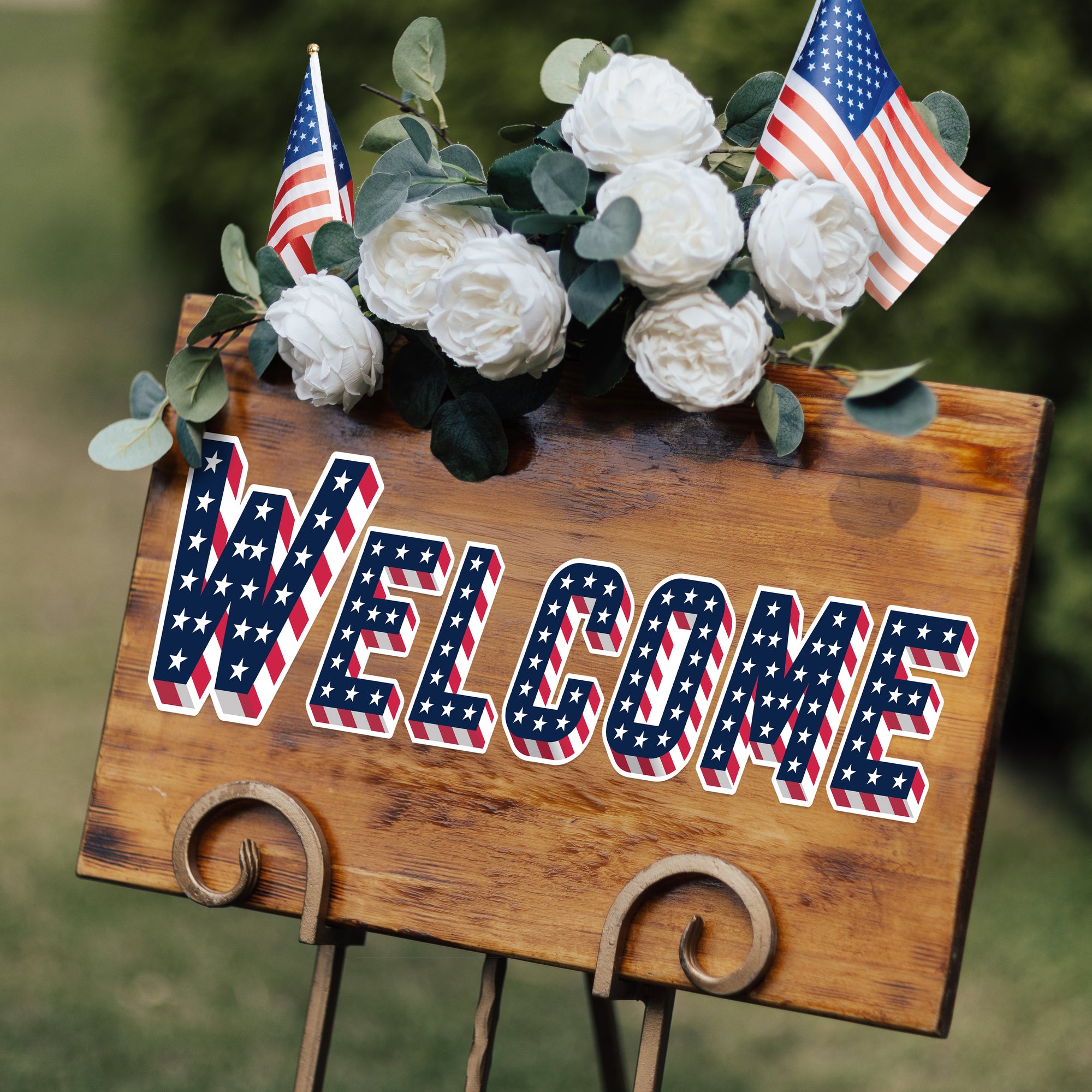 a welcome sign with flowers on top of it
