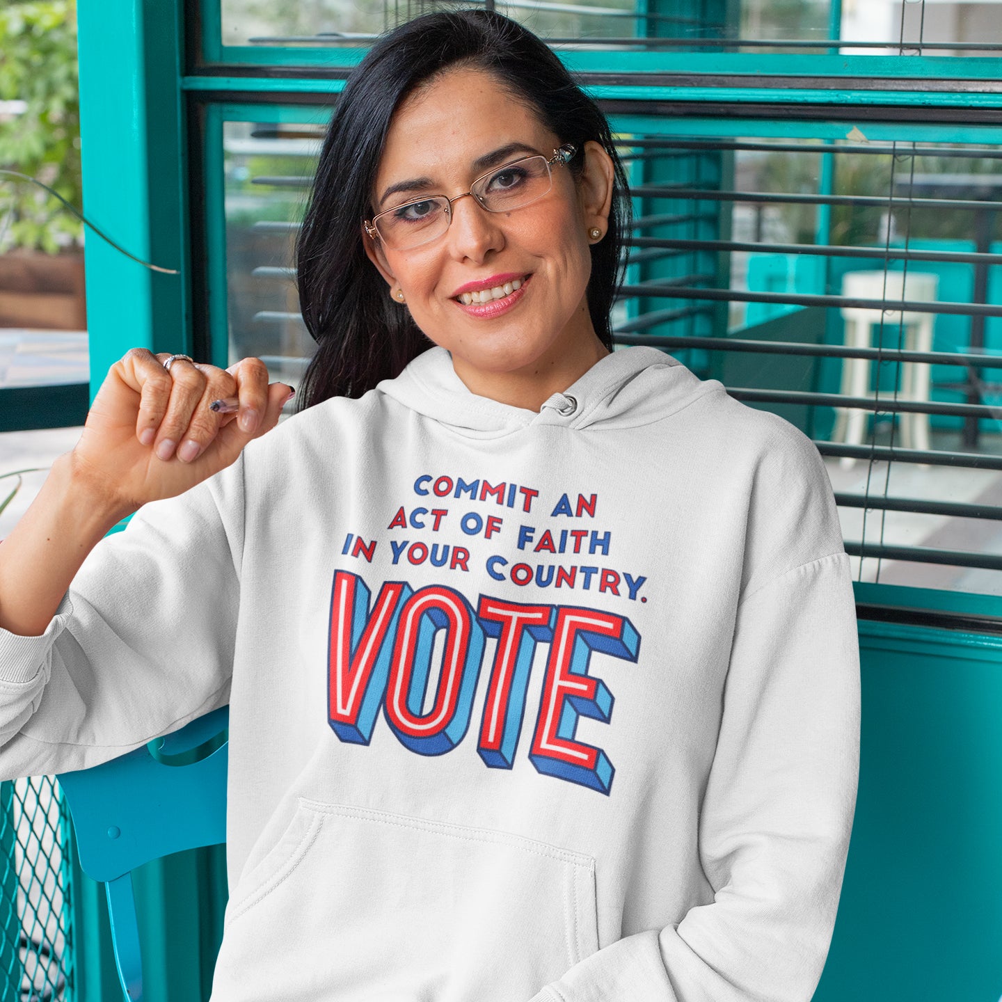 a woman in a white hoodie that says vote