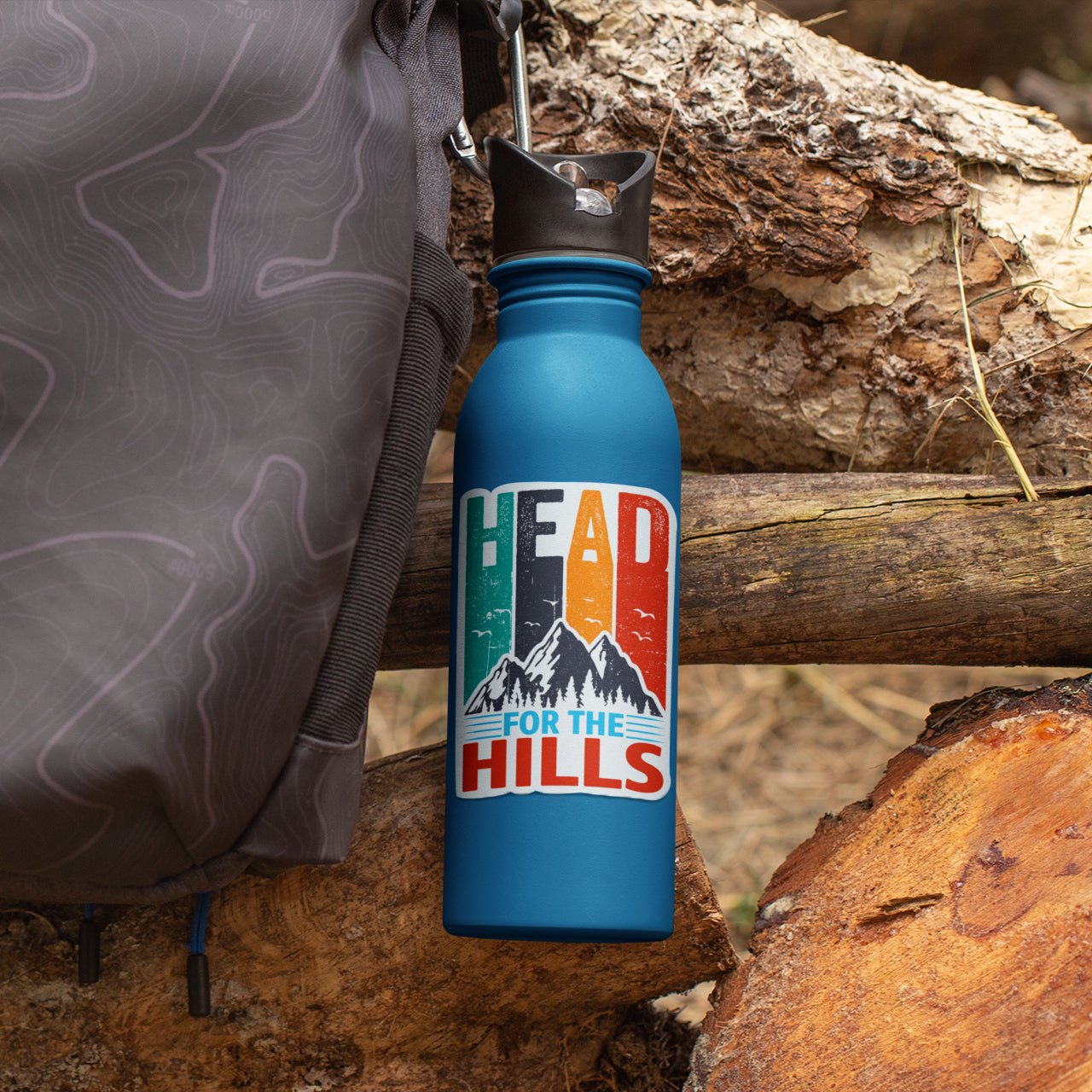 a blue water bottle sitting on top of a pile of wood