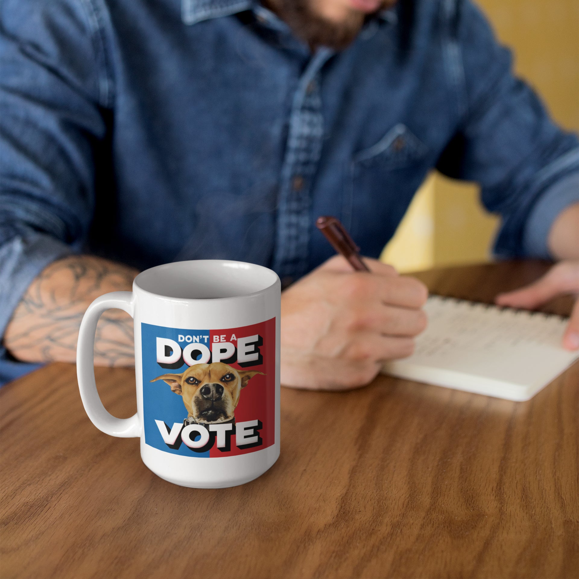 a man sitting at a table with a coffee mug and pen