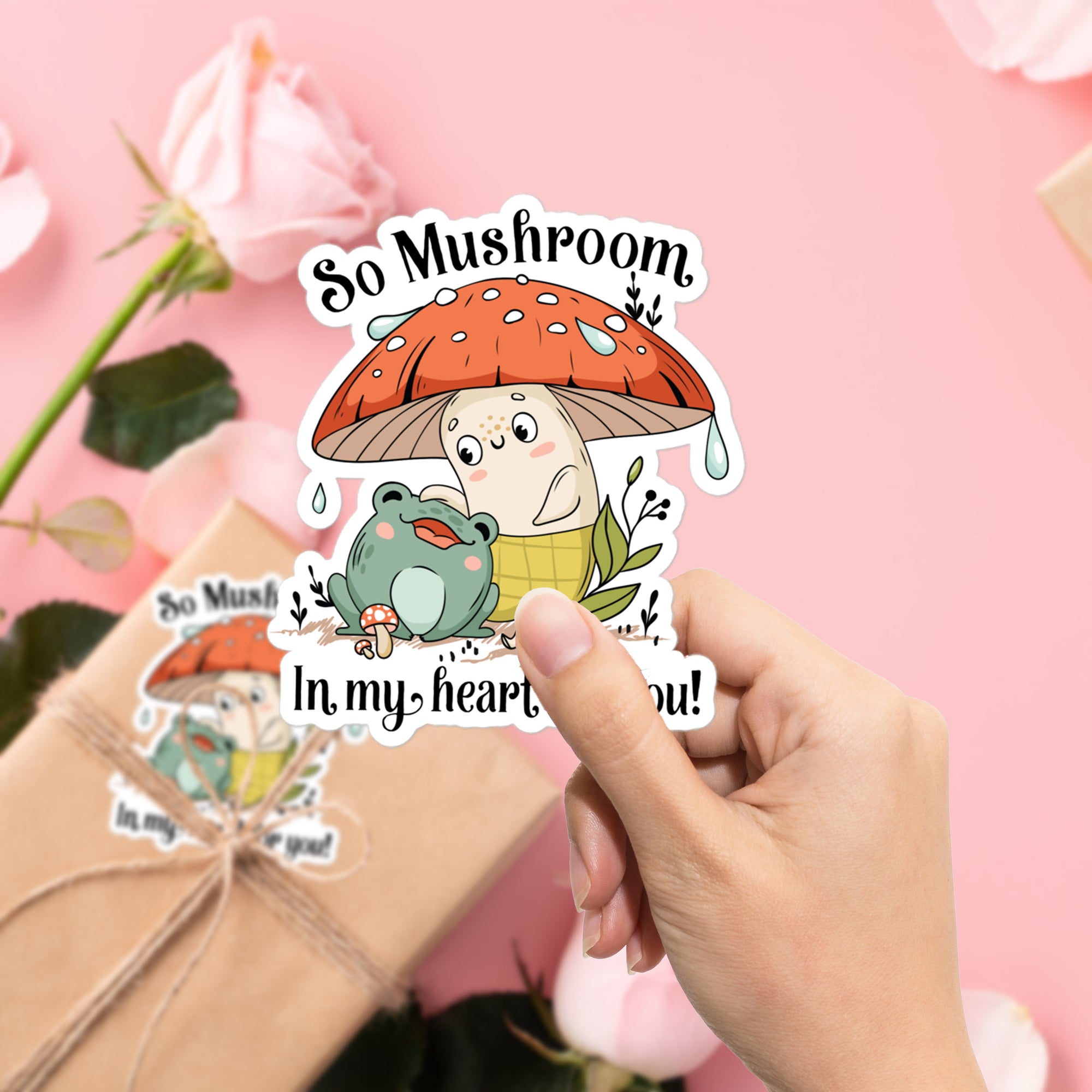 a person holding a sticker with a mushroom on it