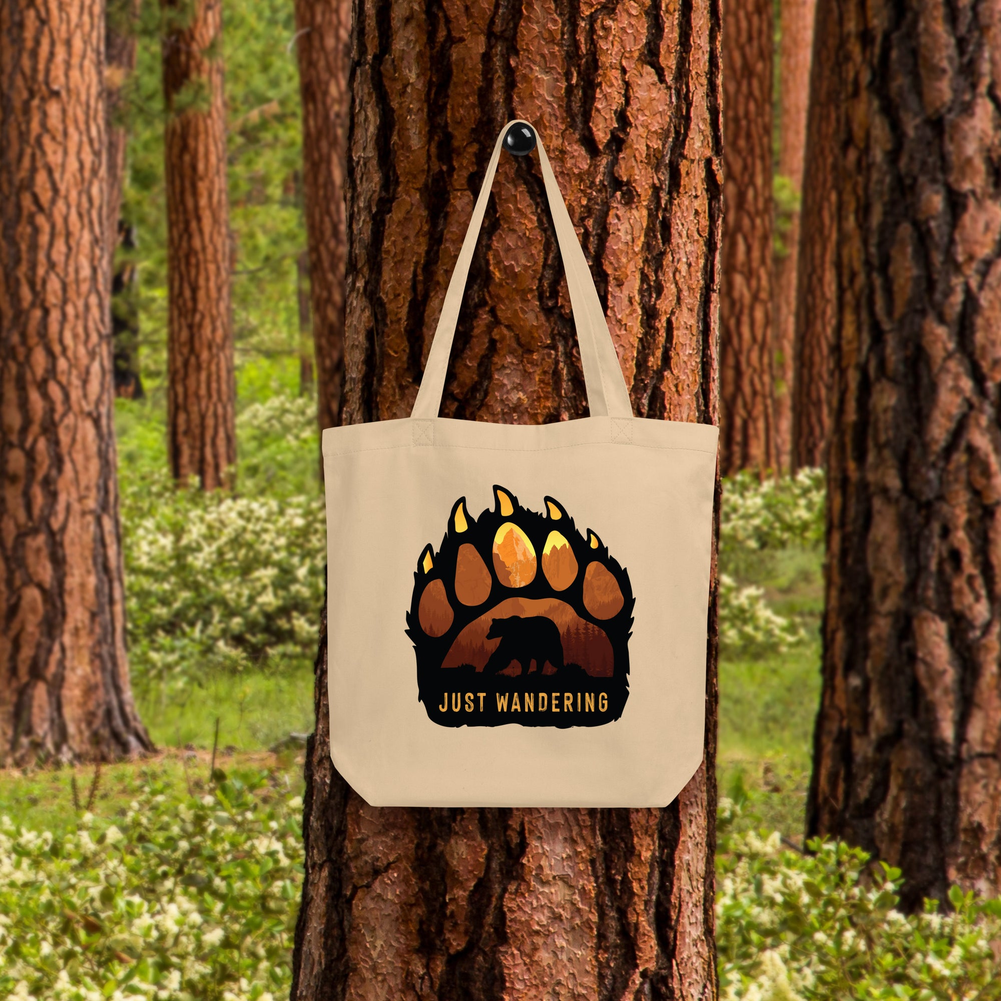 a tote bag hanging on a tree in a forest