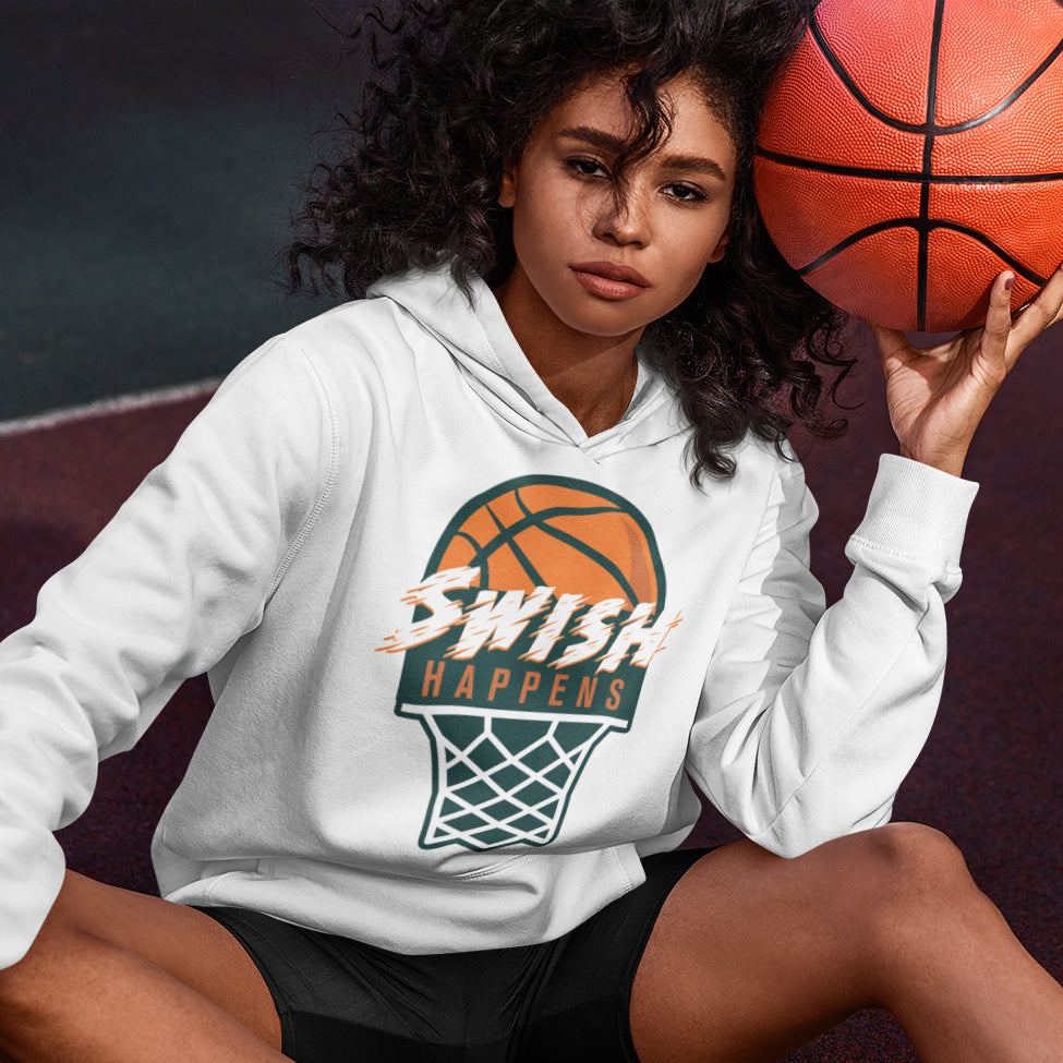 a woman sitting on the ground holding a basketball