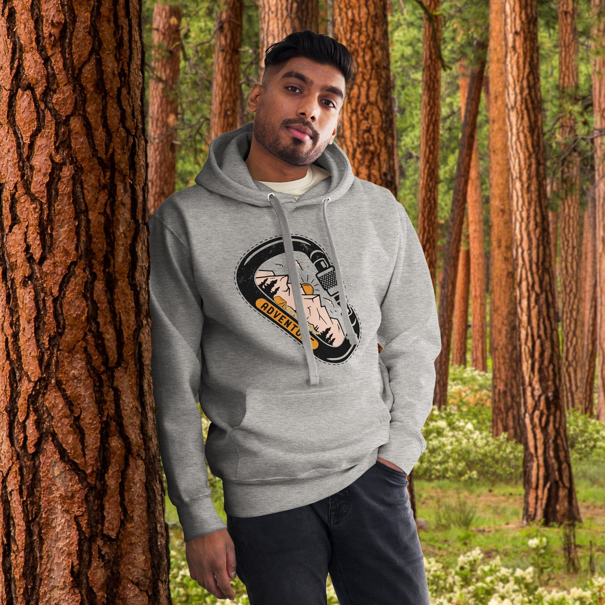 a man standing next to a tree in a forest