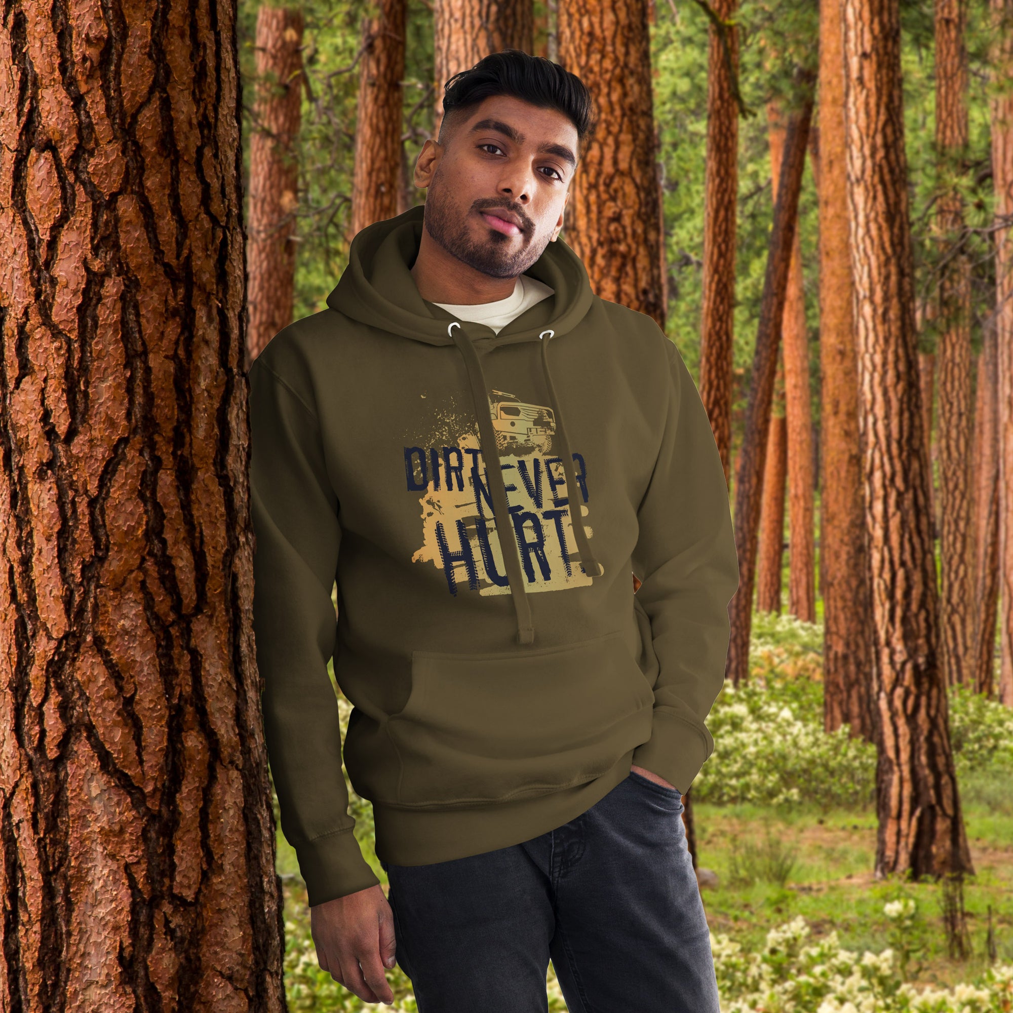 a man standing in front of a tree wearing a hoodie