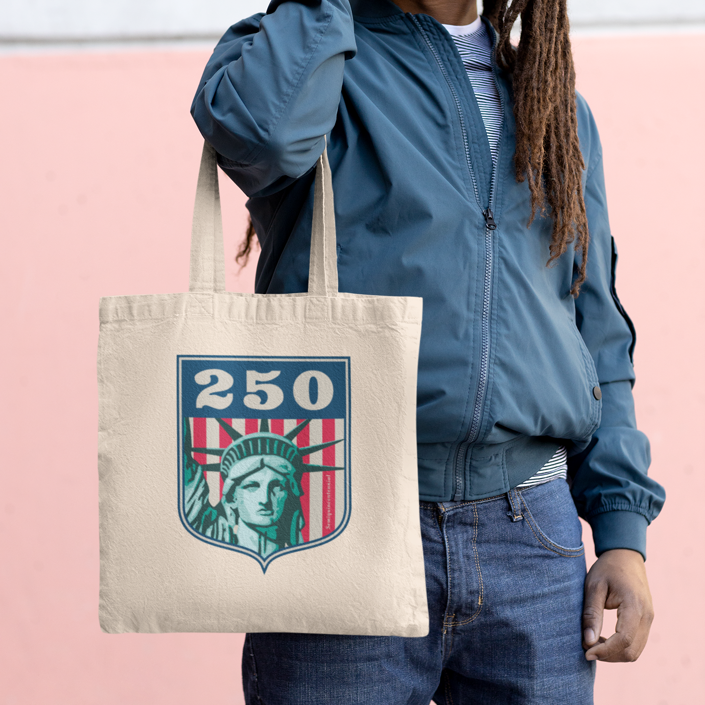 a woman holding a bag with the statue of liberty on it