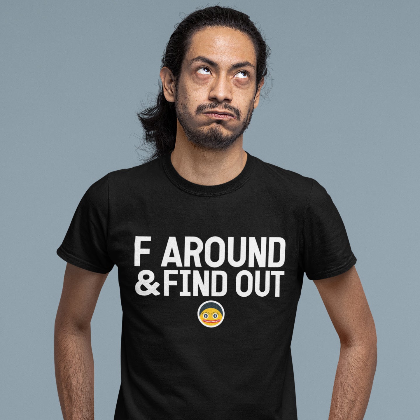 A man wearing a black t-shirt with the text "F AROUND & FIND OUT" printed on it.