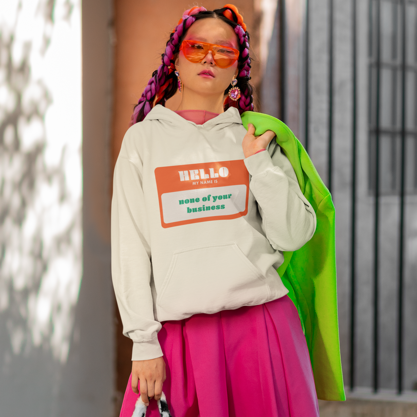 a woman in a white hoodie and pink skirt