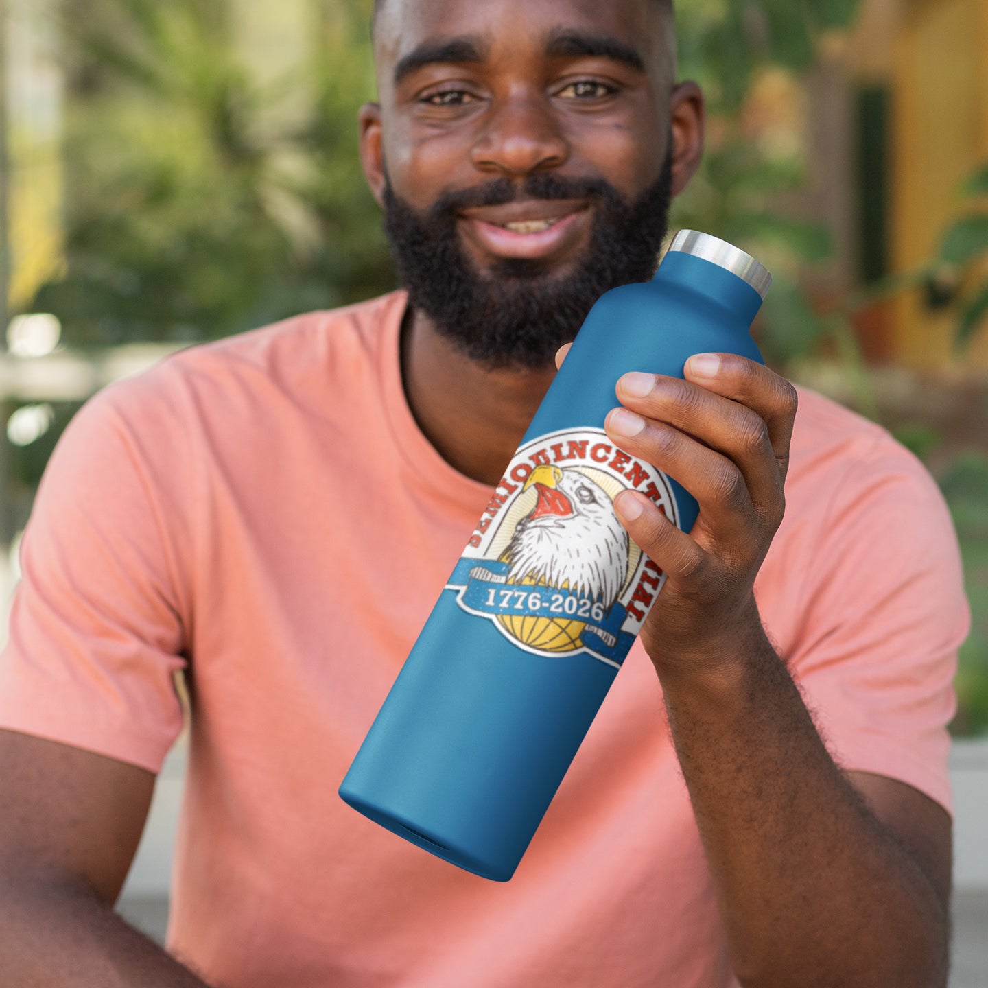 a man is holding a blue water bottle