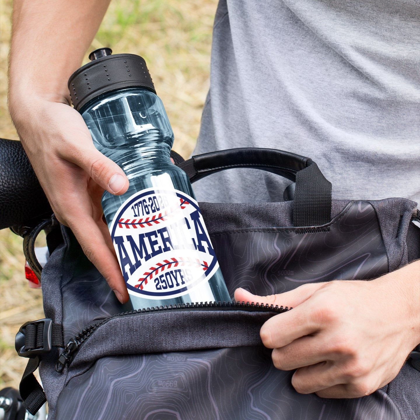 a person holding a bottle in their back pack