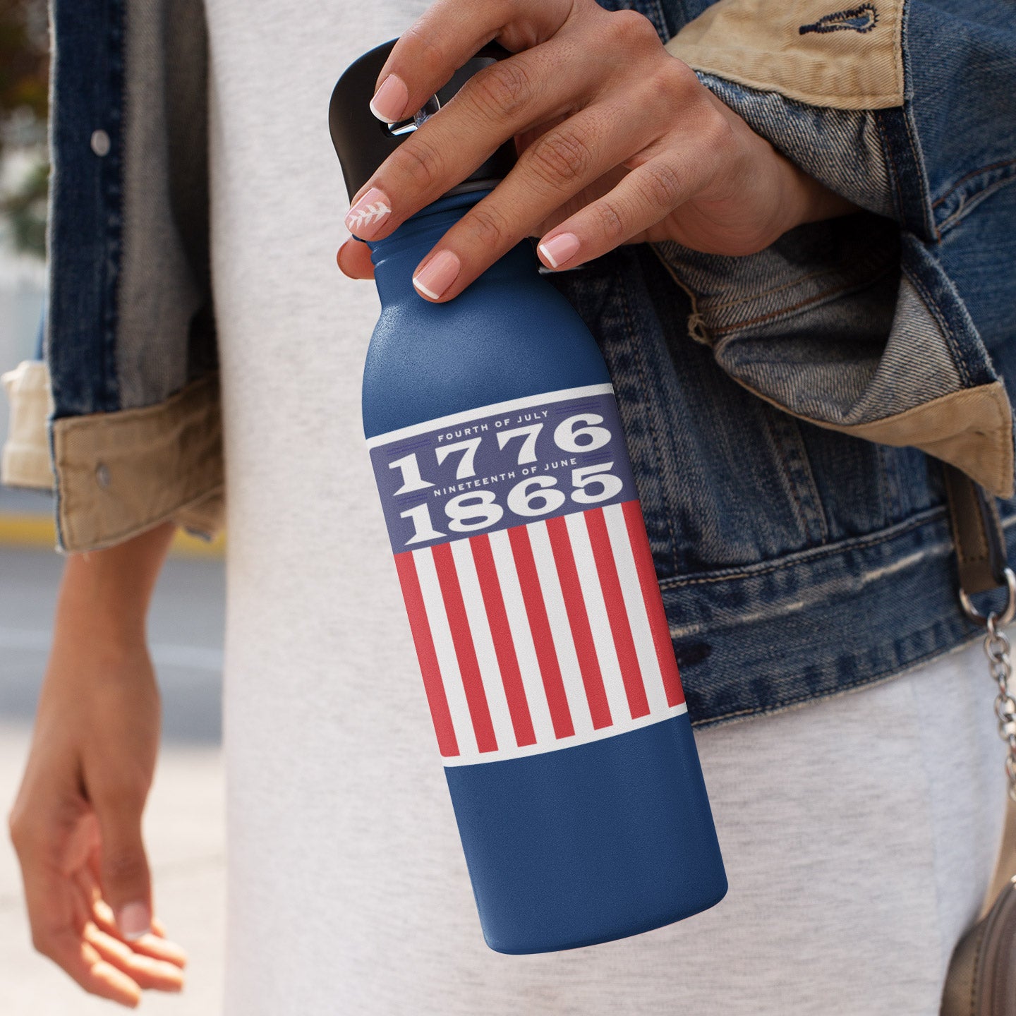 a woman holding a blue water bottle with an american flag on it
