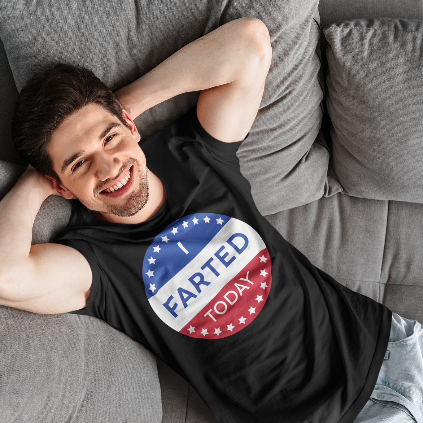 a man laying on a couch wearing a patriotic shirt