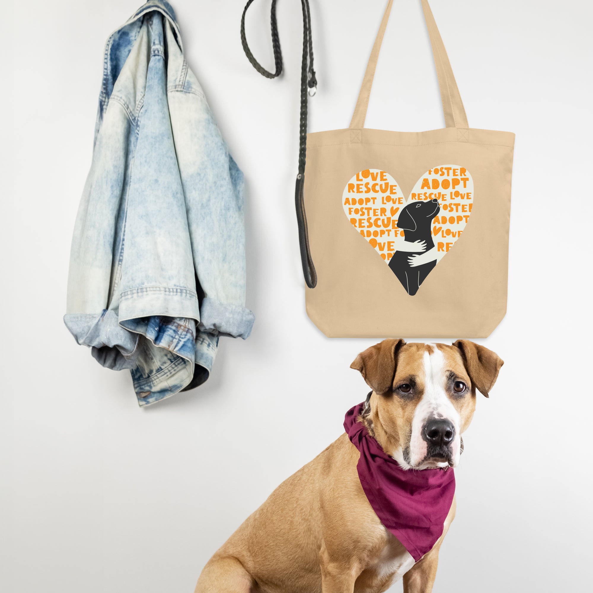 a brown dog sitting next to a tote bag