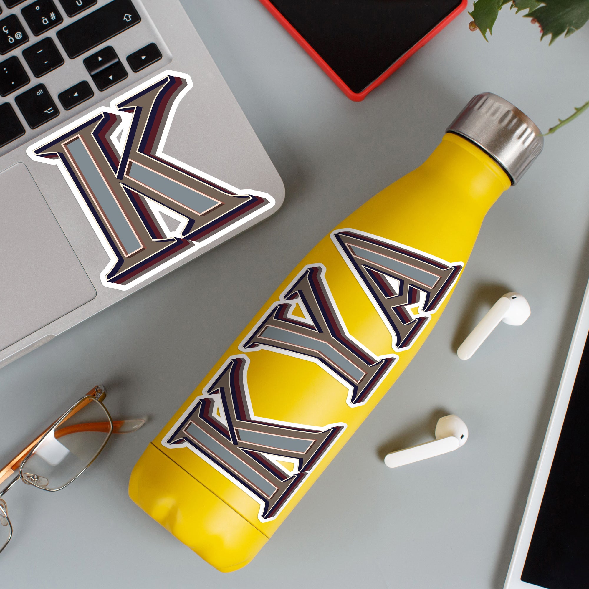 a yellow water bottle sitting next to a laptop