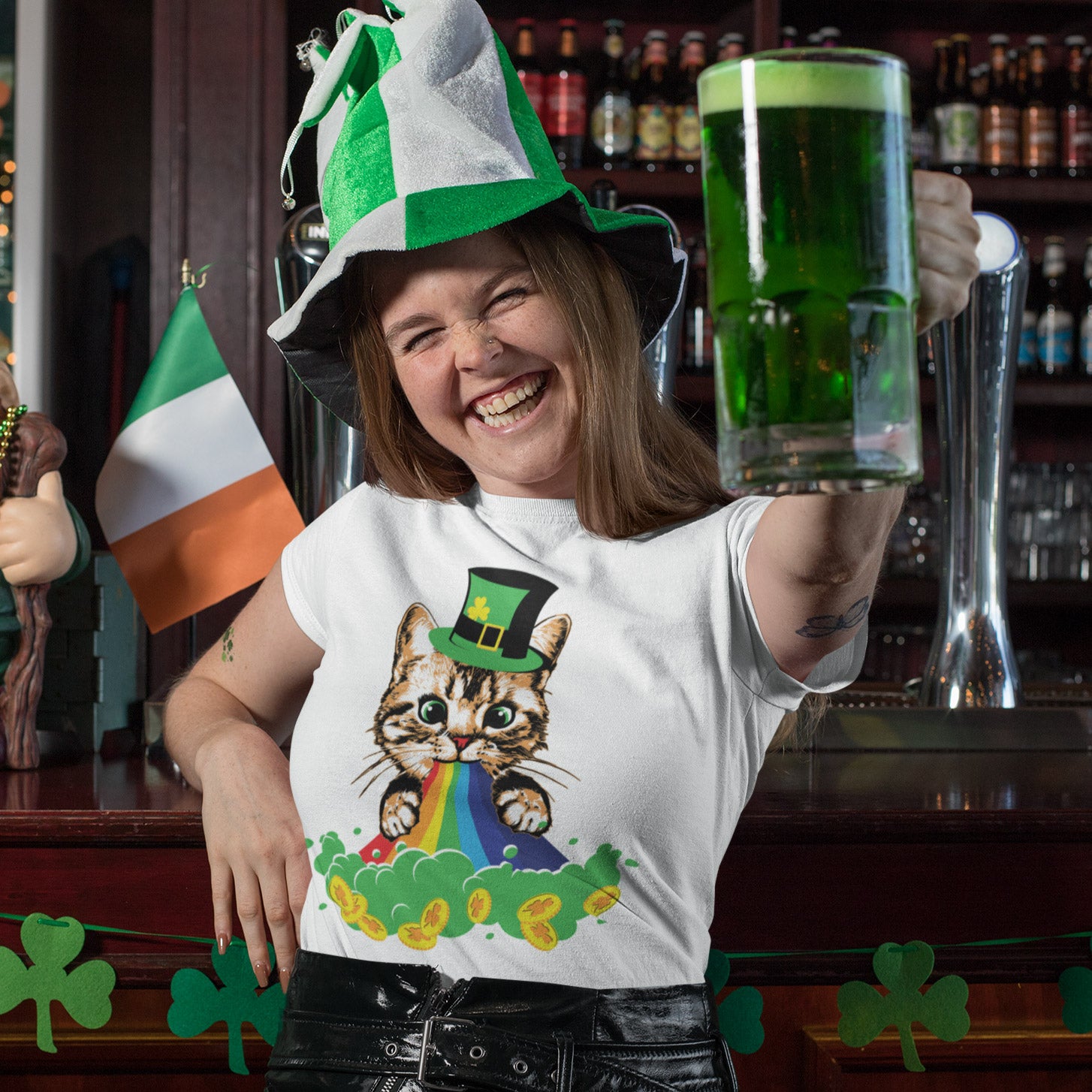 a woman in a st patrick's day t - shirt holding a glass of