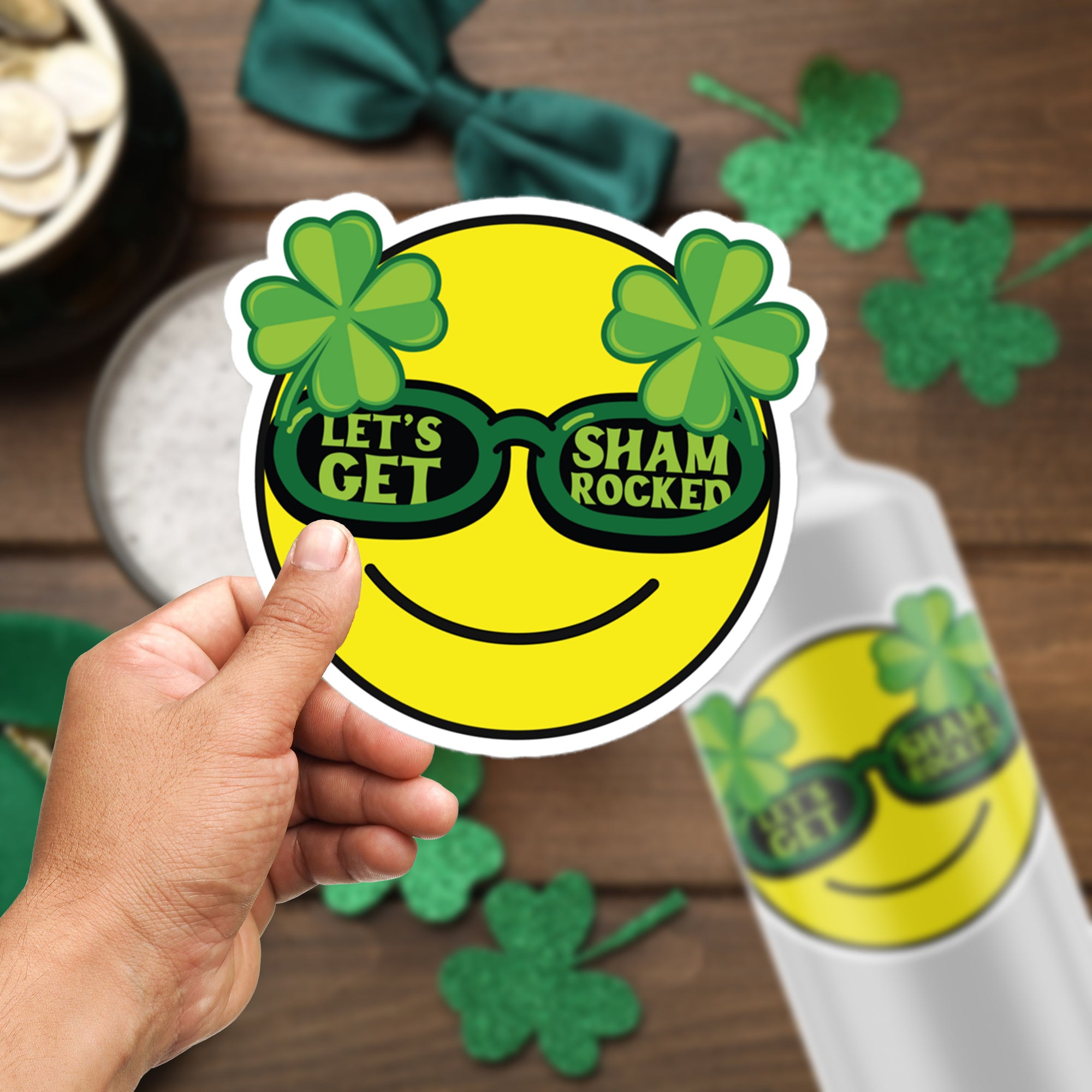 a person holding up a sticker with shamrock glasses on it