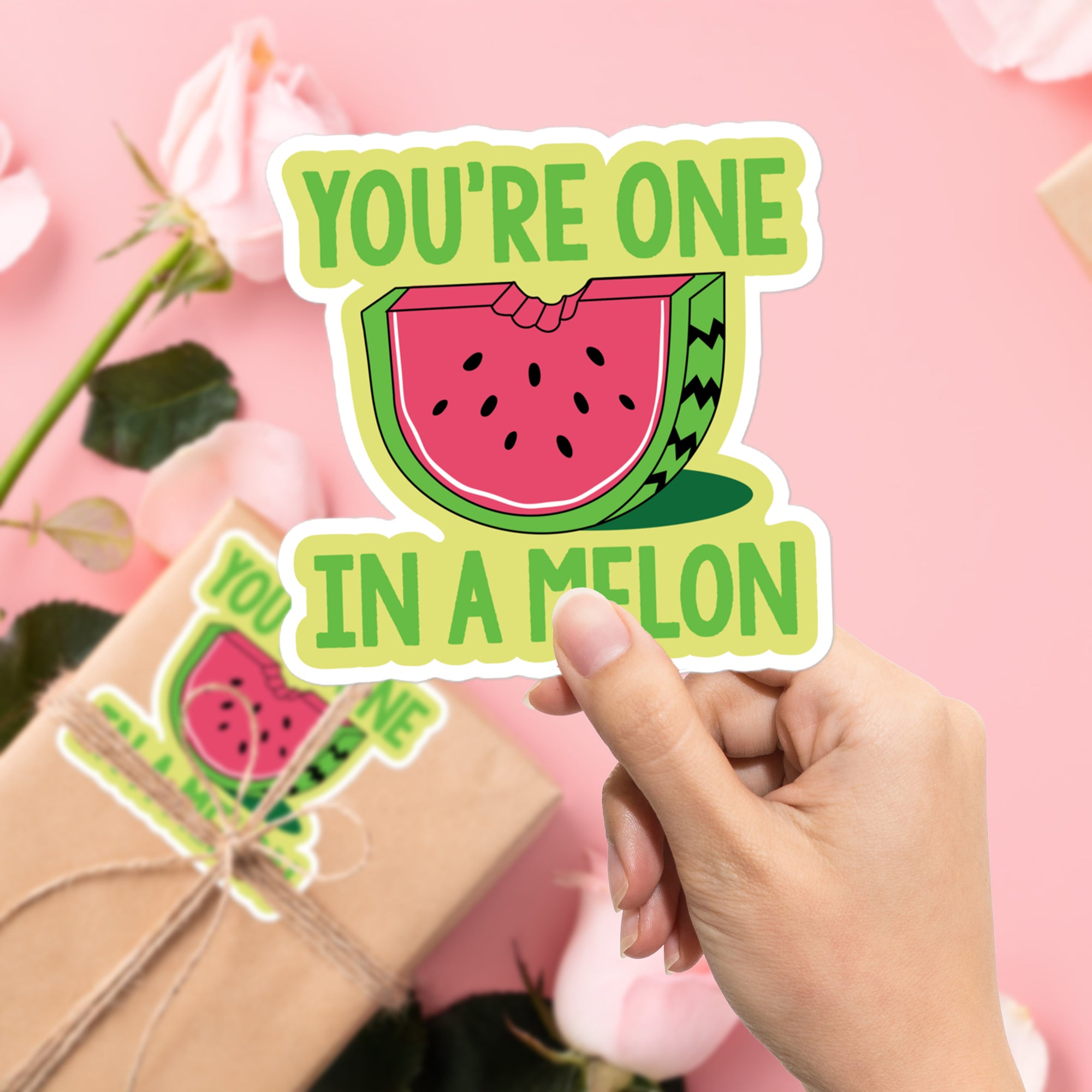 a person holding a sticker that says you're one in a melon