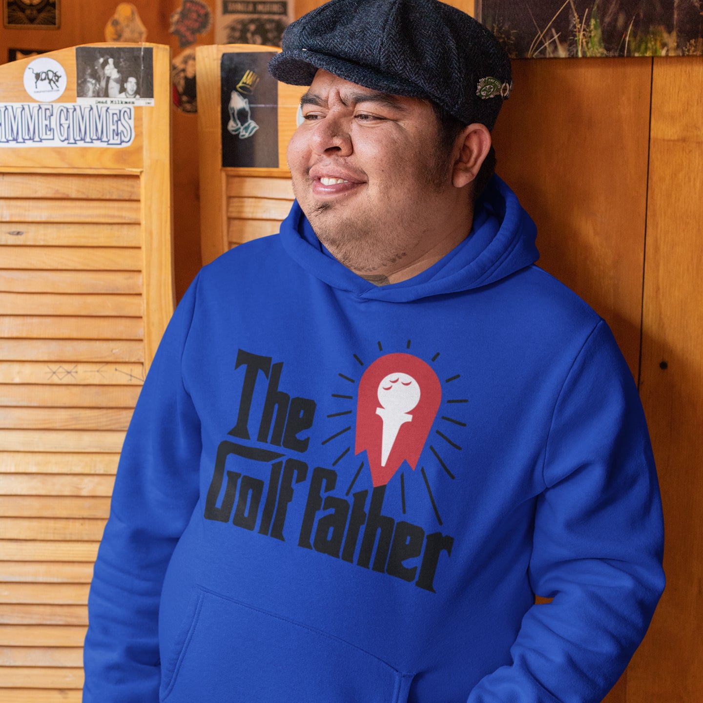 a man wearing a blue hoodie with the word the golf father on it