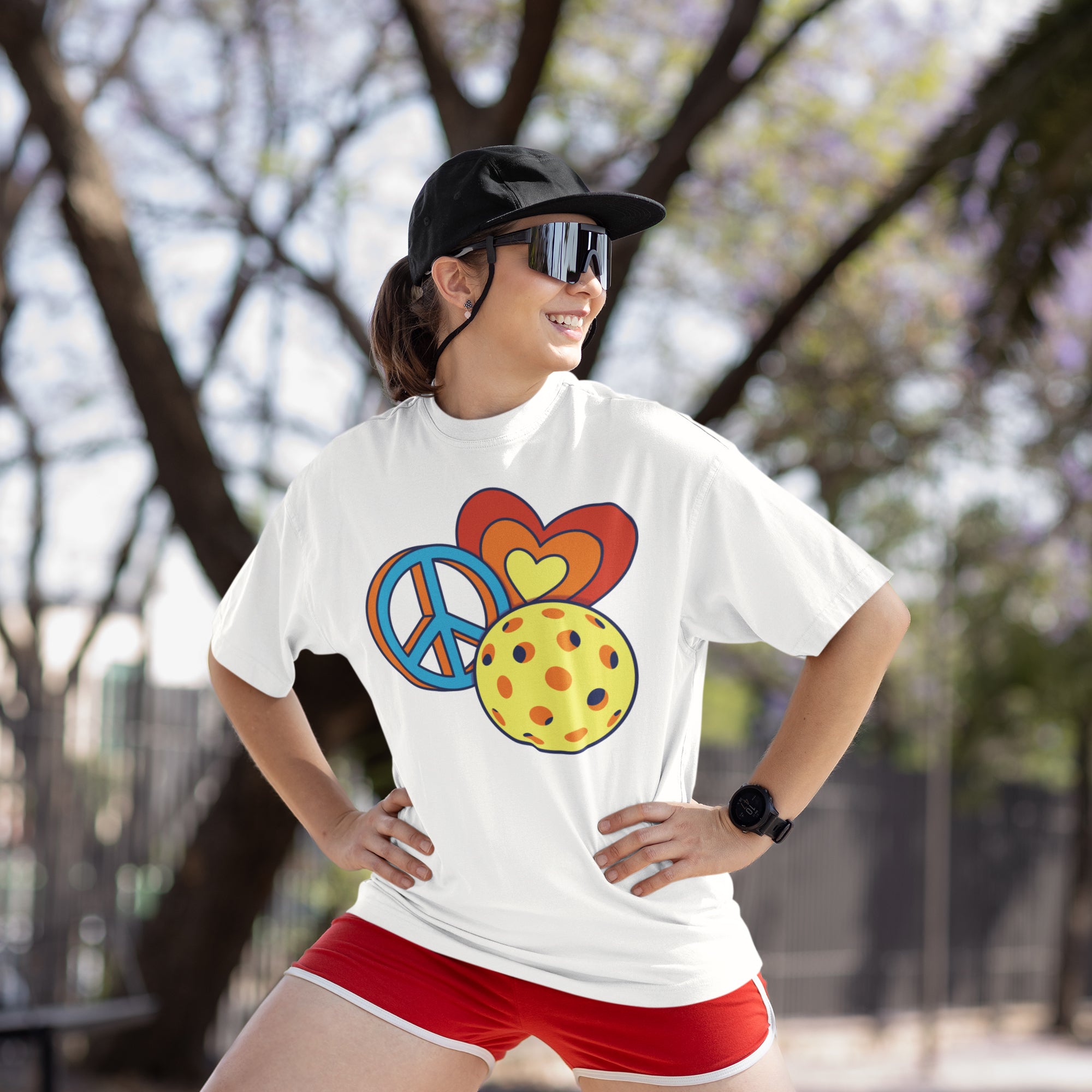 a woman wearing a peace sign t - shirt and red shorts