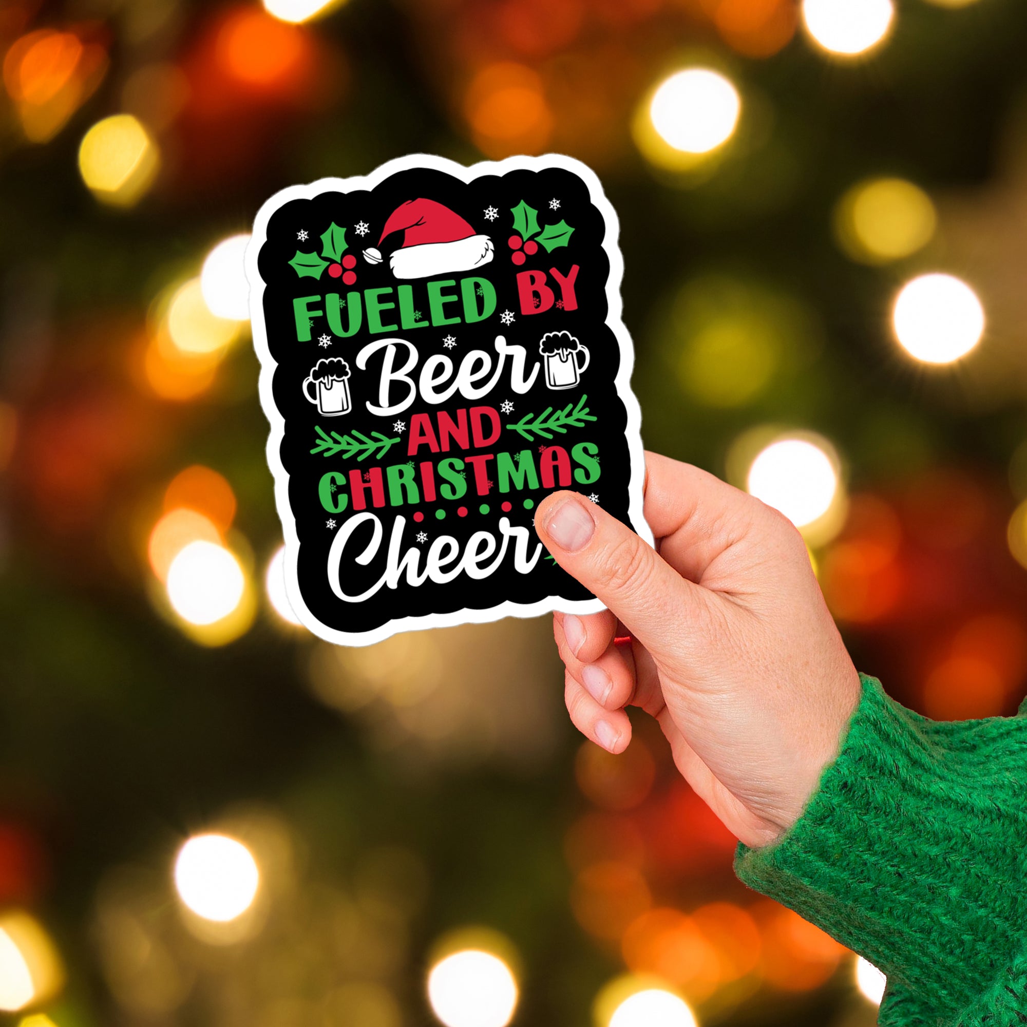 a hand holding a sticker that says fueled by beer and christmas cheer