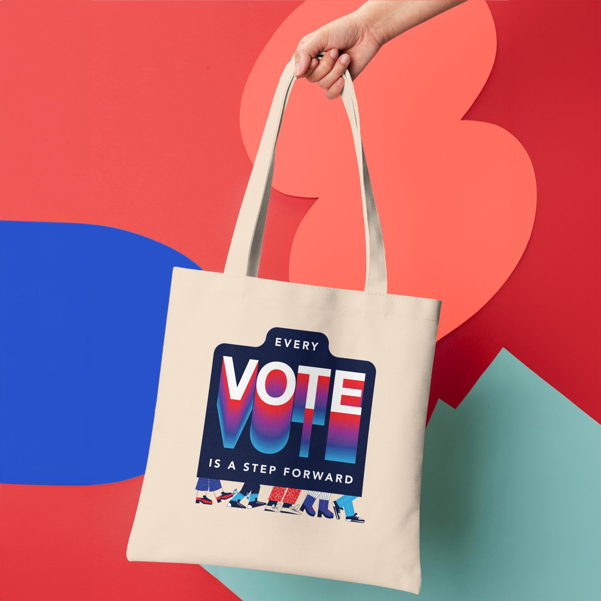 a person holding a tote bag with a vote sign on it