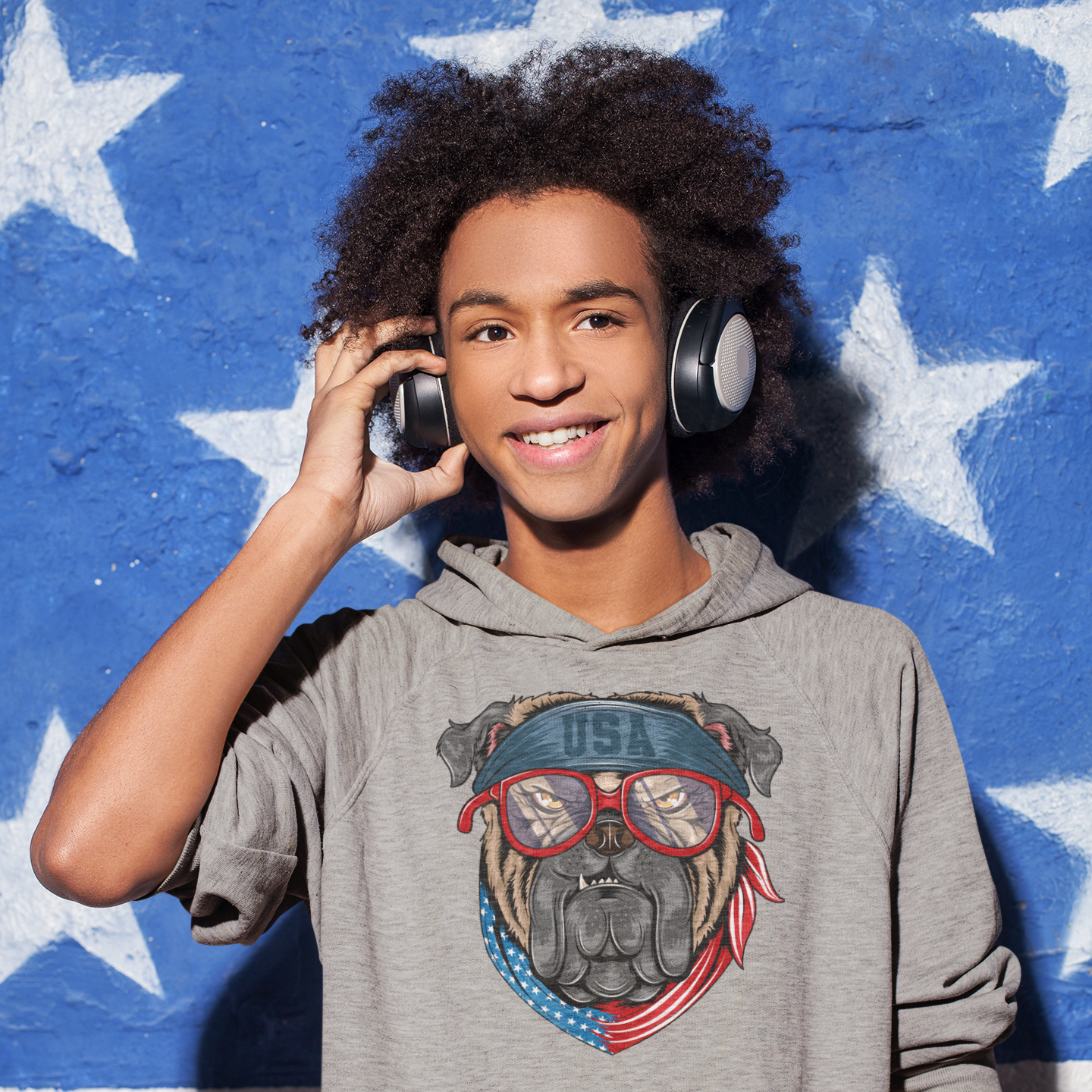 a young boy wearing headphones while talking on a cell phone