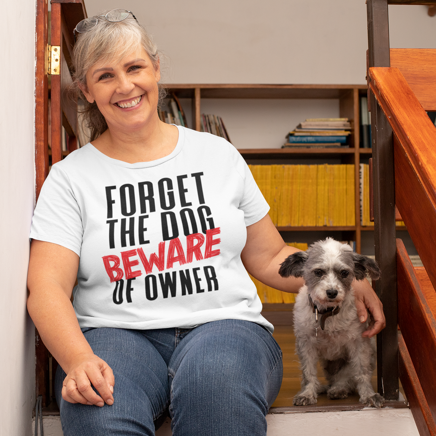 a woman sitting on a step next to a dog