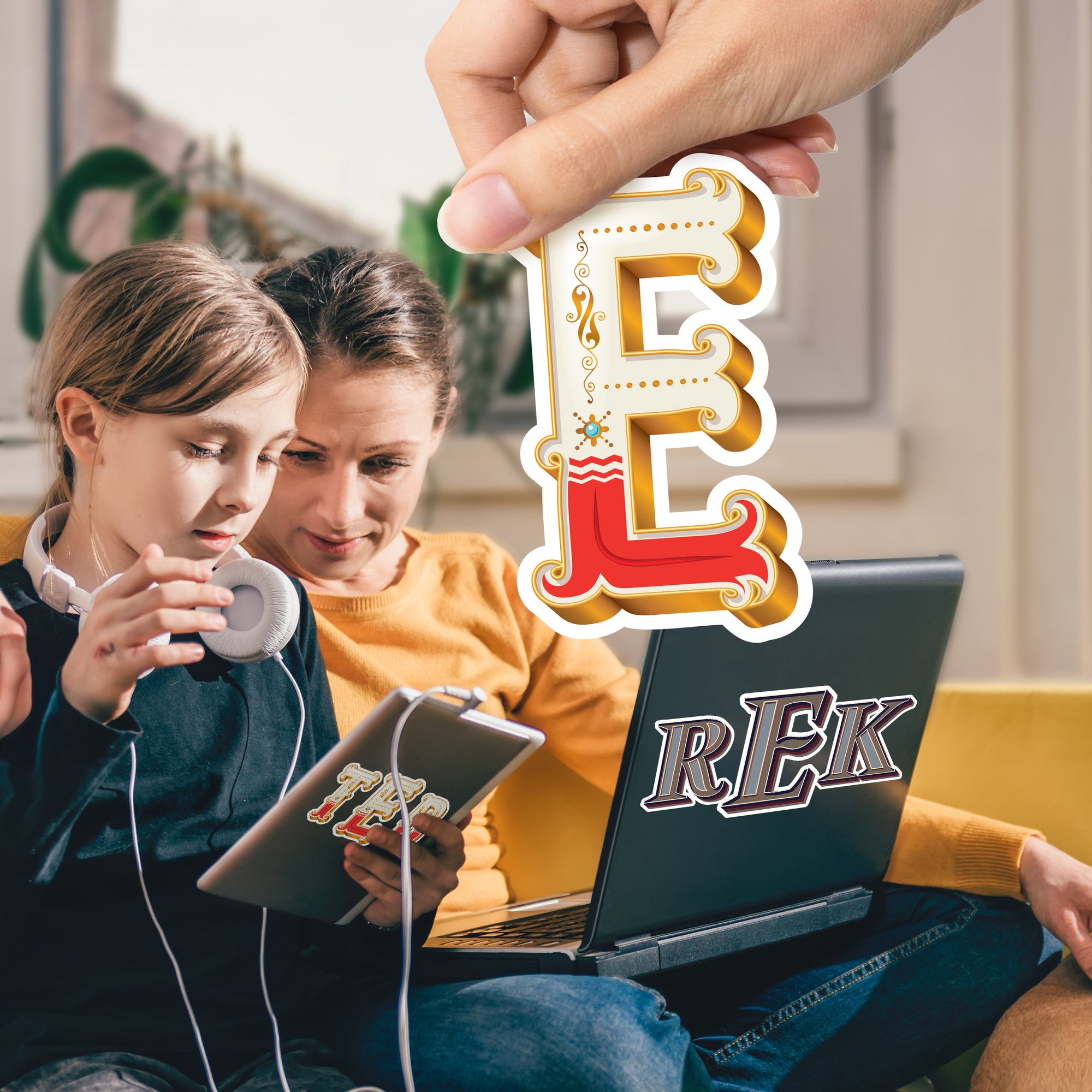 a couple of people sitting on a couch with a laptop