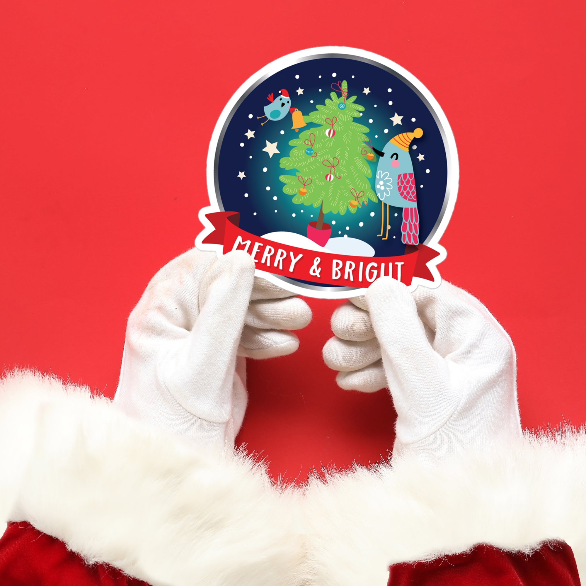 a person in a santa suit holding up a merry and bright sticker