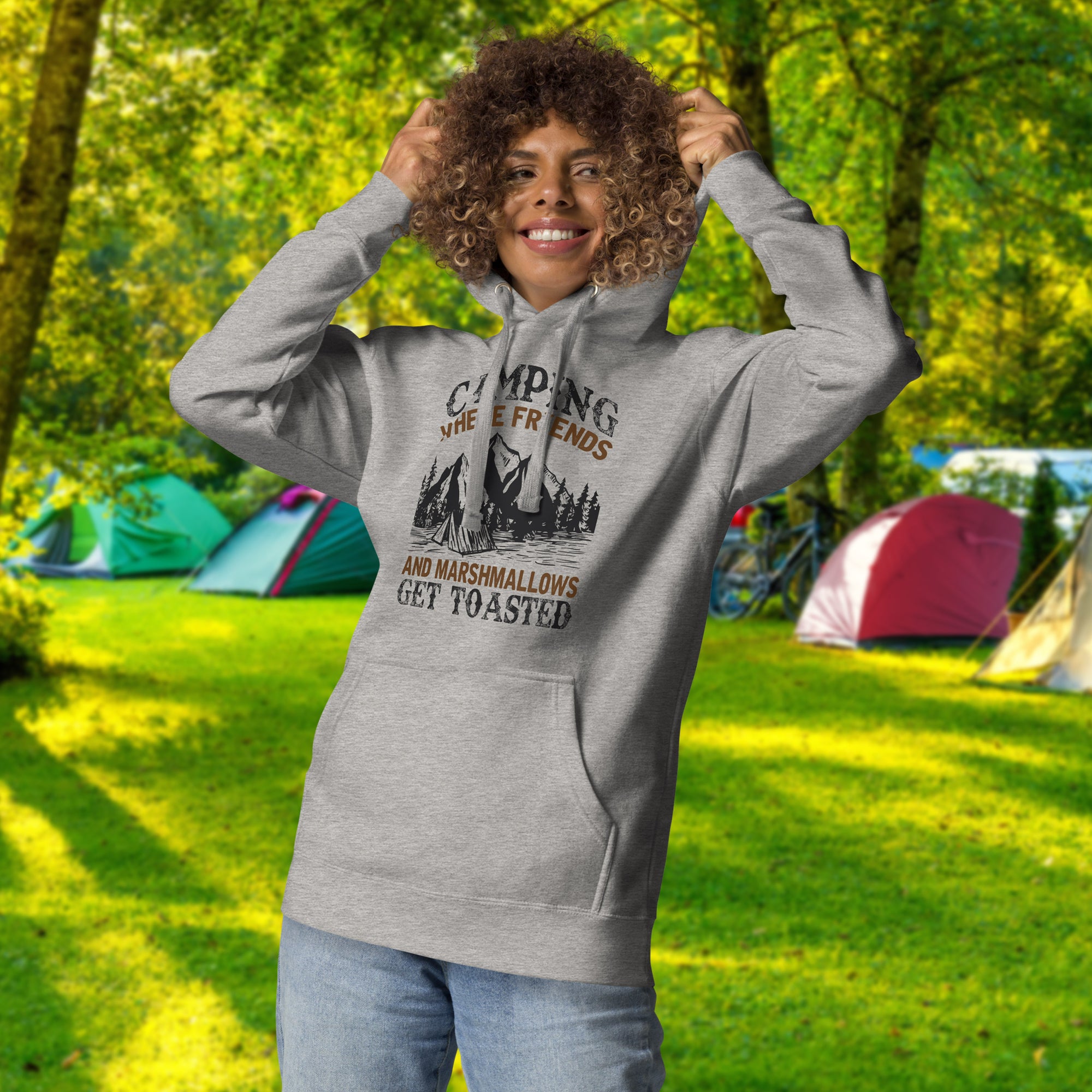 a woman standing in a field with a hoodie on