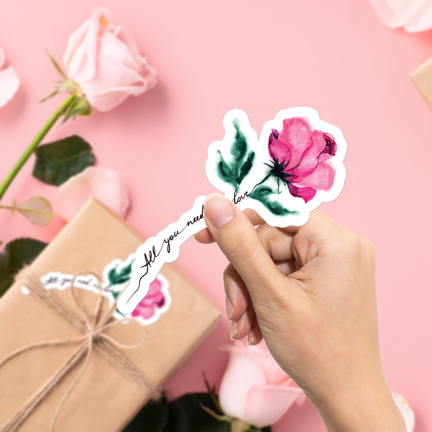 a person holding a sticker with a rose on it