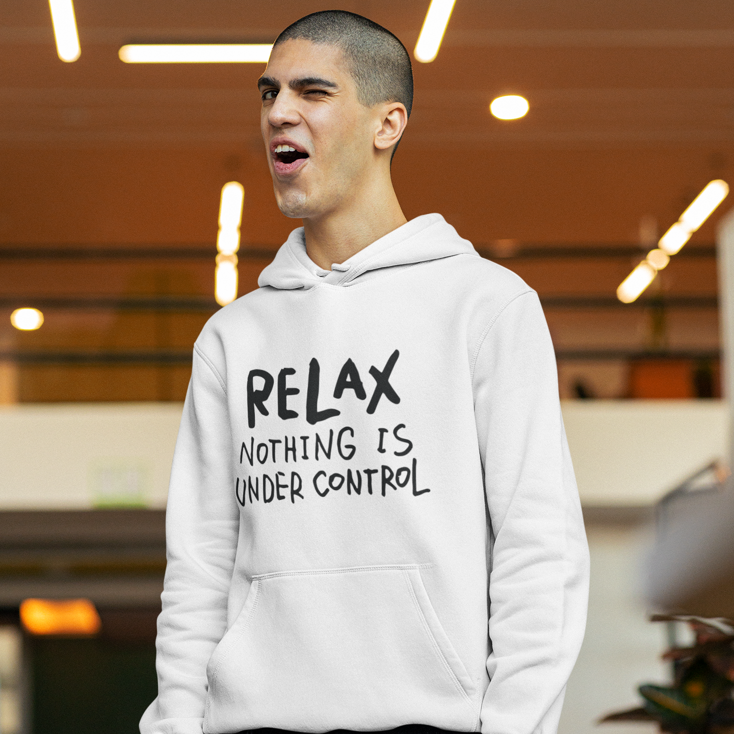 a man with a hoodie that says relax nothing is under control