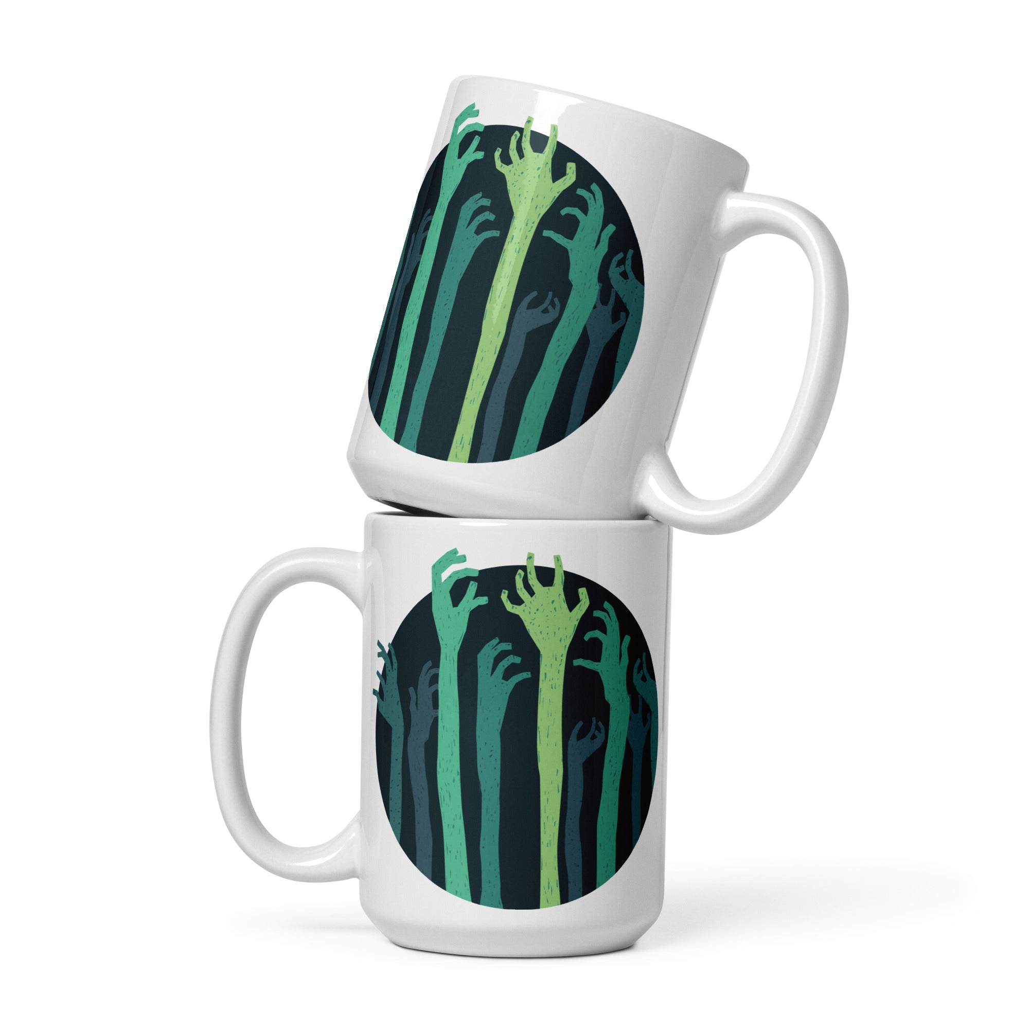 two white coffee mugs with green hands on them