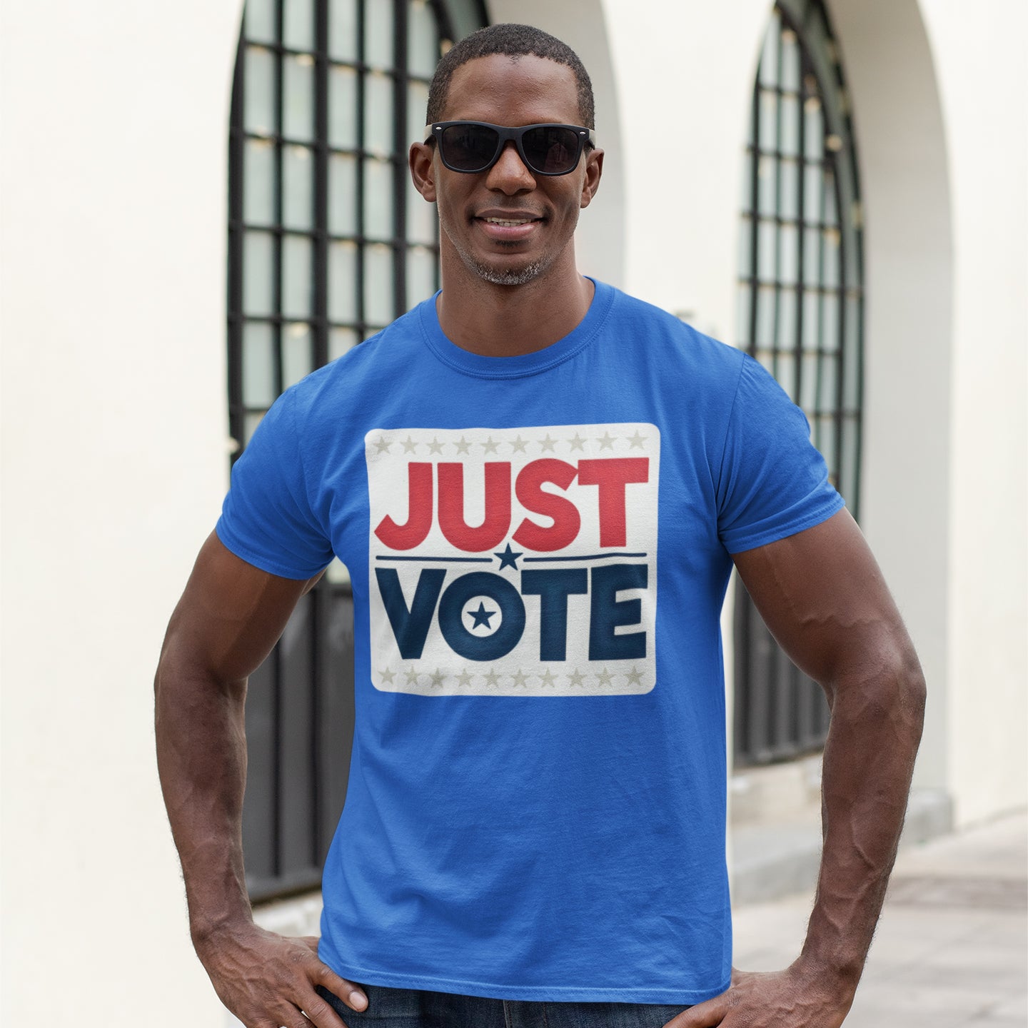 a man wearing a blue shirt that says just vote